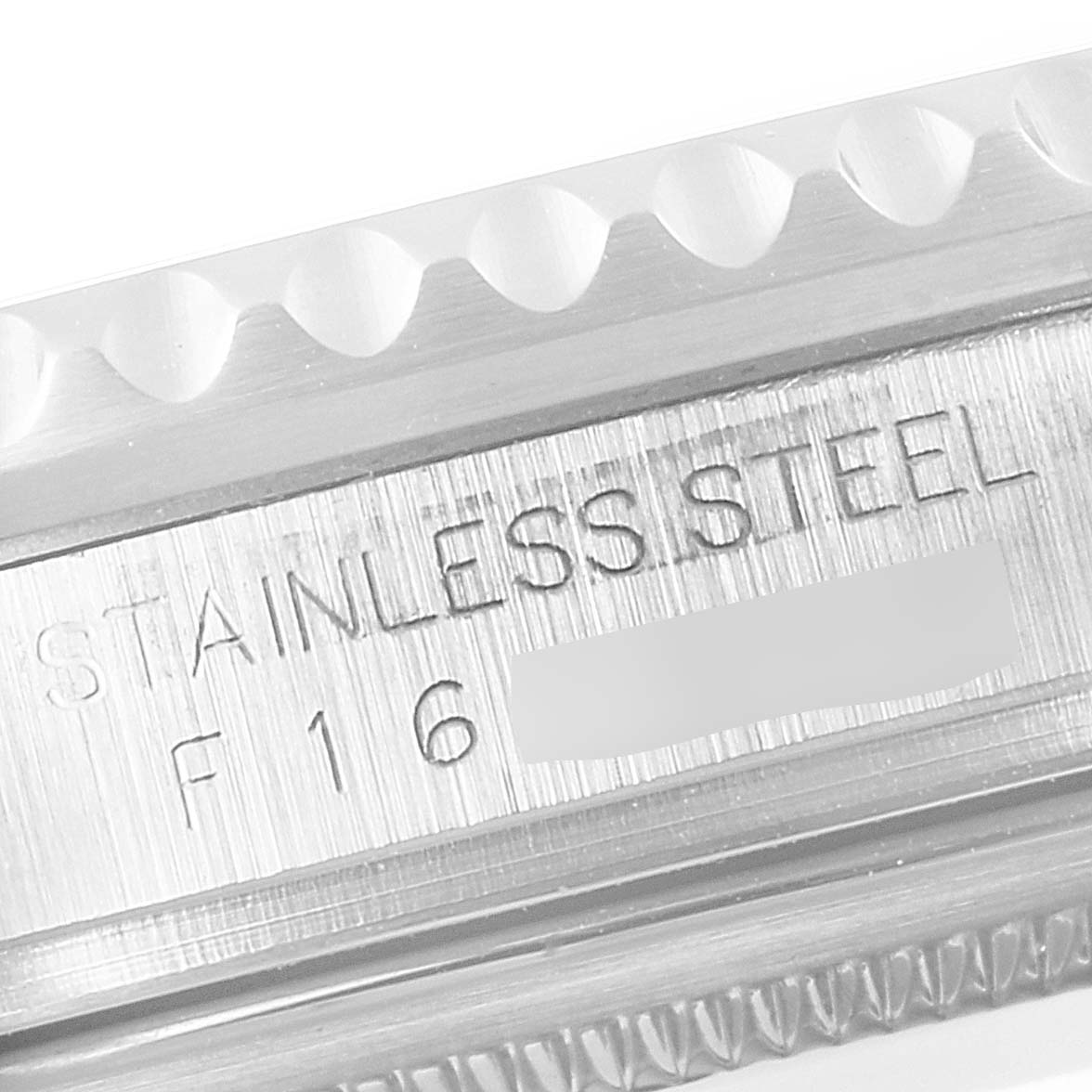 The image shows a close-up of the side of a stainless steel Rolex GMT-Master 16710 Men
s Stainless Steel Black Dial 16710 Men
s Stainless Steel Black Dial, highlighting its engraved serial number.