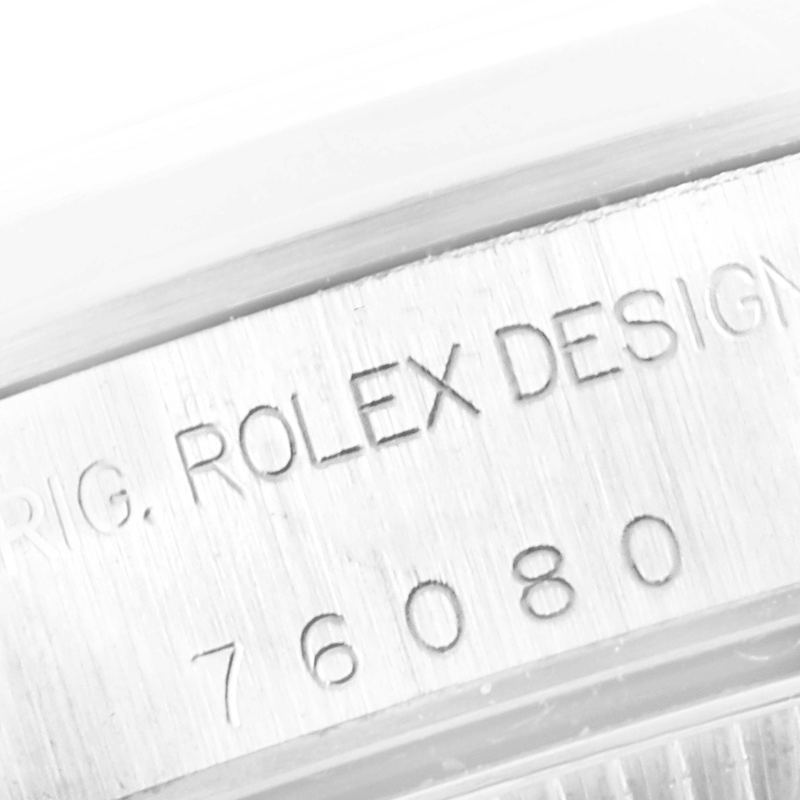 The image shows a close-up of the serial number and "Rolex Design" engraving on the case side of an Oyster Perpetual model by Rolex.