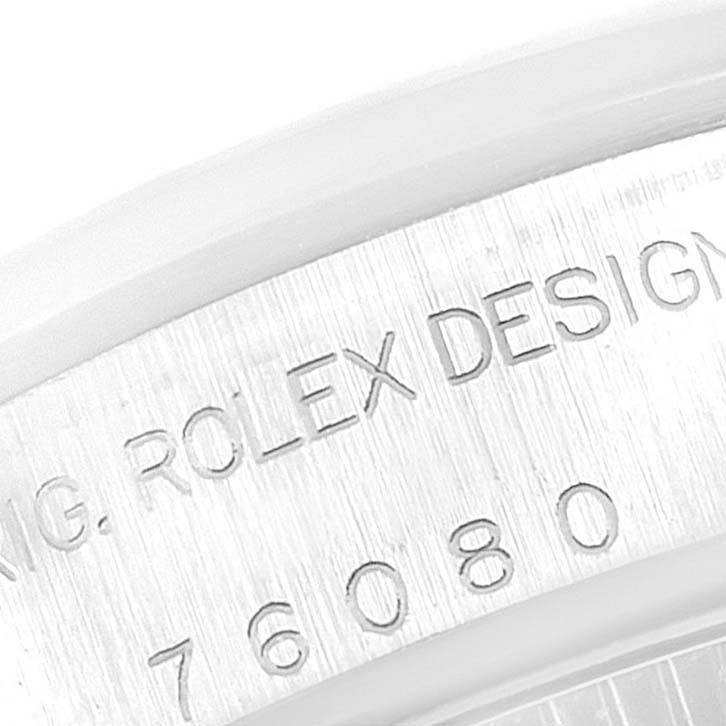 This close-up image shows the engraved Rolex branding and design number on the casing of a Rolex Oyster Perpetual 76080 Women
s Stainless Steel Pink Dial 76080 Women
s Stainless Steel Pink Dial watch.