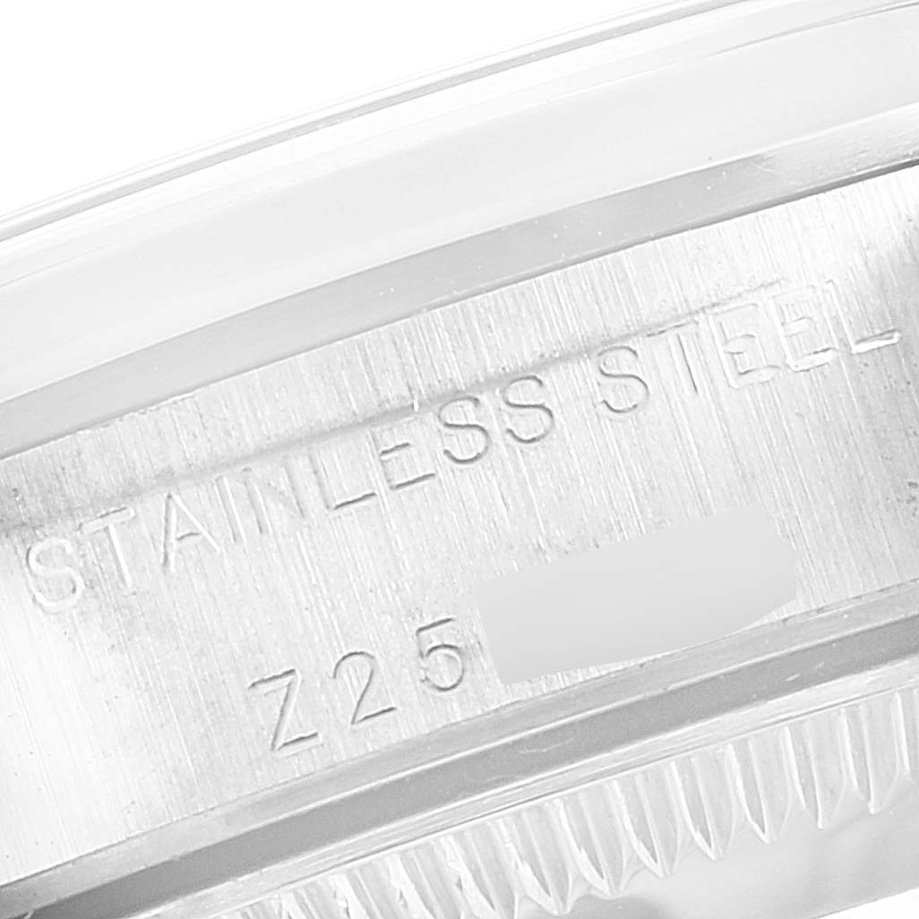 This image shows an engraved "Stainless Steel" inscription and serial number on the side of a Rolex Oyster Perpetual 76080 Women
s Stainless Steel Pink Dial 76080 Women
s Stainless Steel Pink Dial watch case.