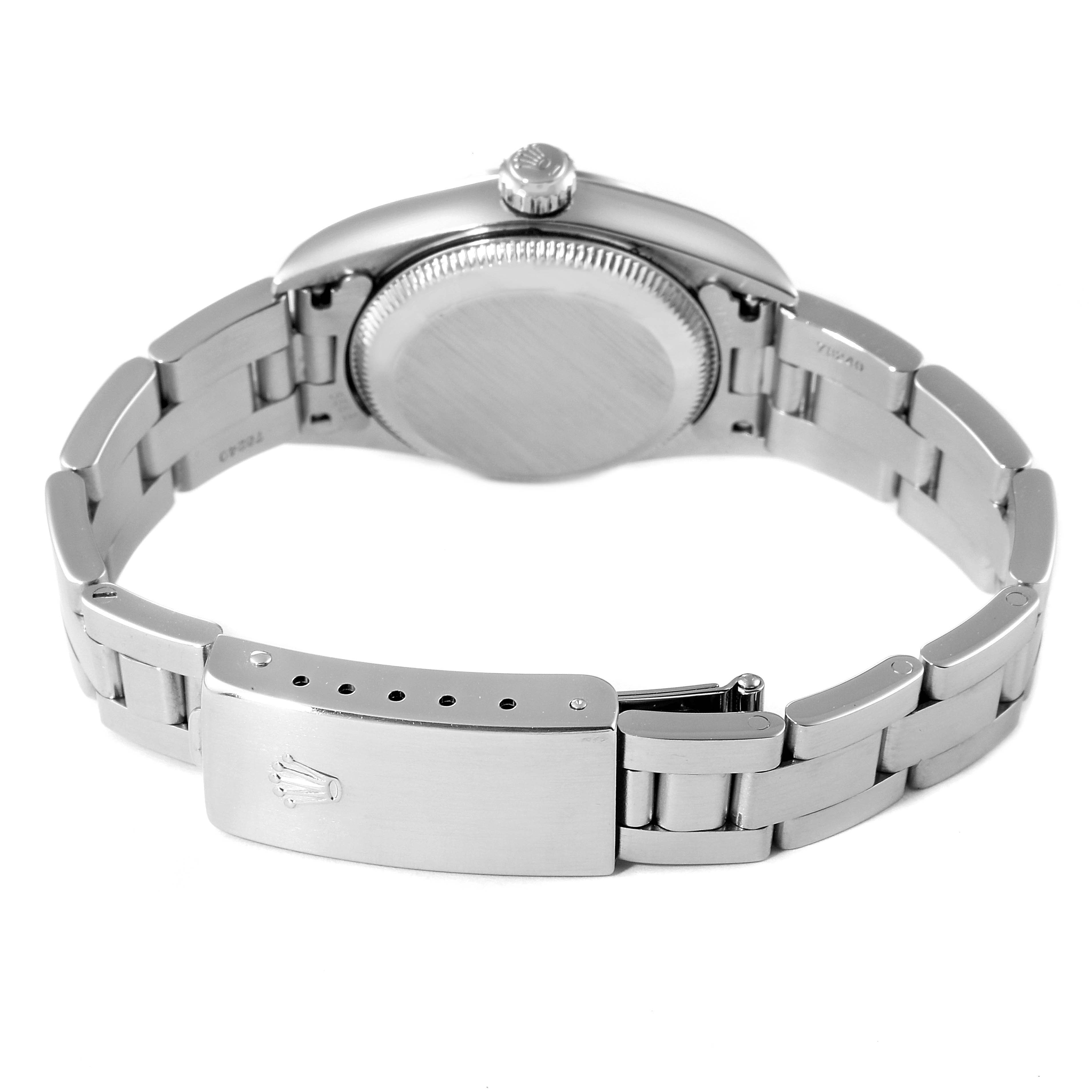 The image shows the backside and clasp of the Rolex Oyster Perpetual 76080 Women
s Stainless Steel Pink Dial 76080 Women
s Stainless Steel Pink Dial watch, focusing on the case back, crown, and bracelet.