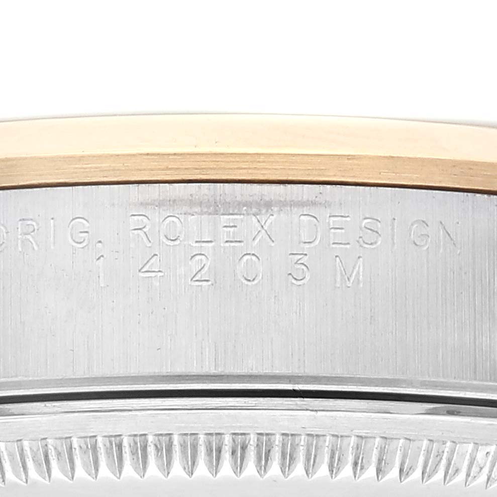 This image shows a close-up of the engraved side of the bezel and case for an Oyster Perpetual model by Rolex.