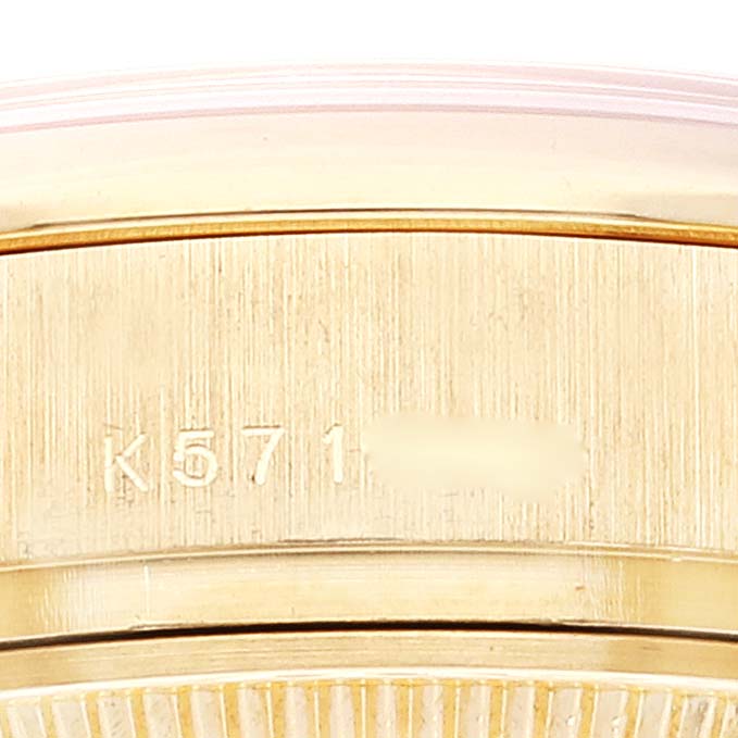 This close-up image shows the side of a Rolex President 179298 Women
s Yellow Gold Champagne Dial 179298 Women
s Yellow Gold Champagne Dial model watch, highlighting the engraved serial number on the case.