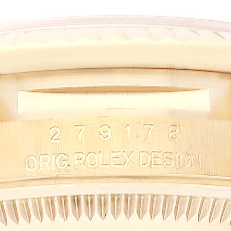 This close-up of a Rolex President 279178 Women's Yellow Gold Champagne Dial 279178 Women's Yellow Gold Champagne Dial model watch shows the serial number and "ORIG. ROLEX DESIGN" engraving.