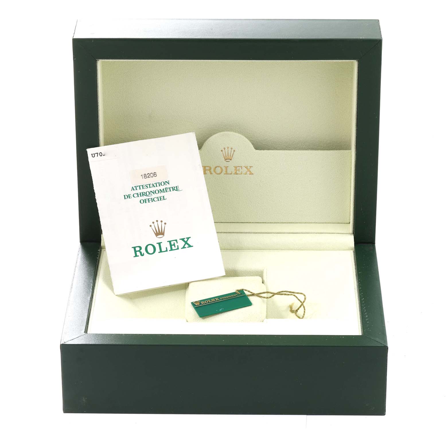 This image shows the open box of a Rolex President 18206 Men's Platinum Blue Dial 18206 Men's Platinum Blue Dial model with documentation and a tag, viewed from the front.