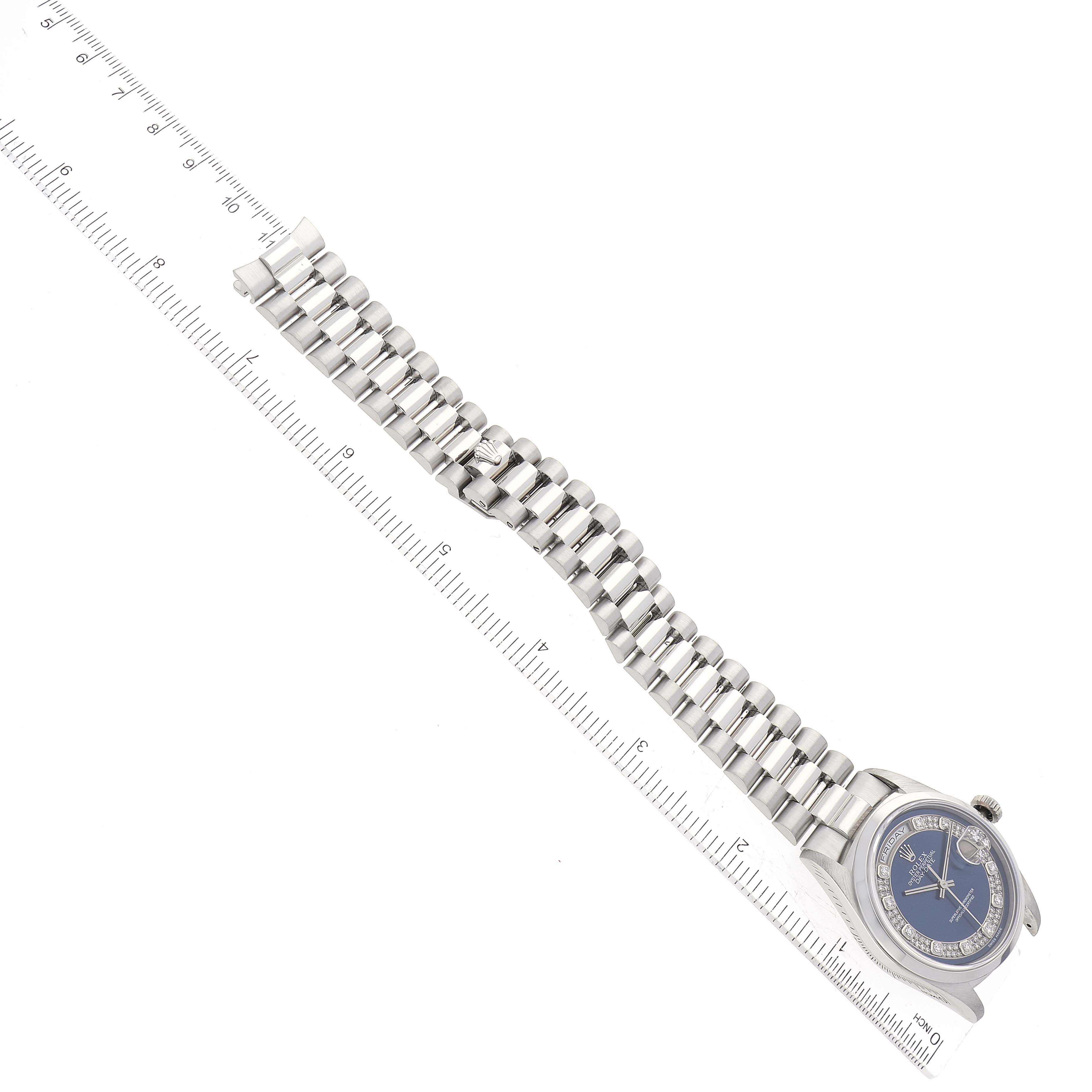 The image shows an overhead view of a Rolex President 18206 Men's Platinum Blue Dial 18206 Men's Platinum Blue Dial model, highlighting its bracelet and dial with a ruler beside it for scale.