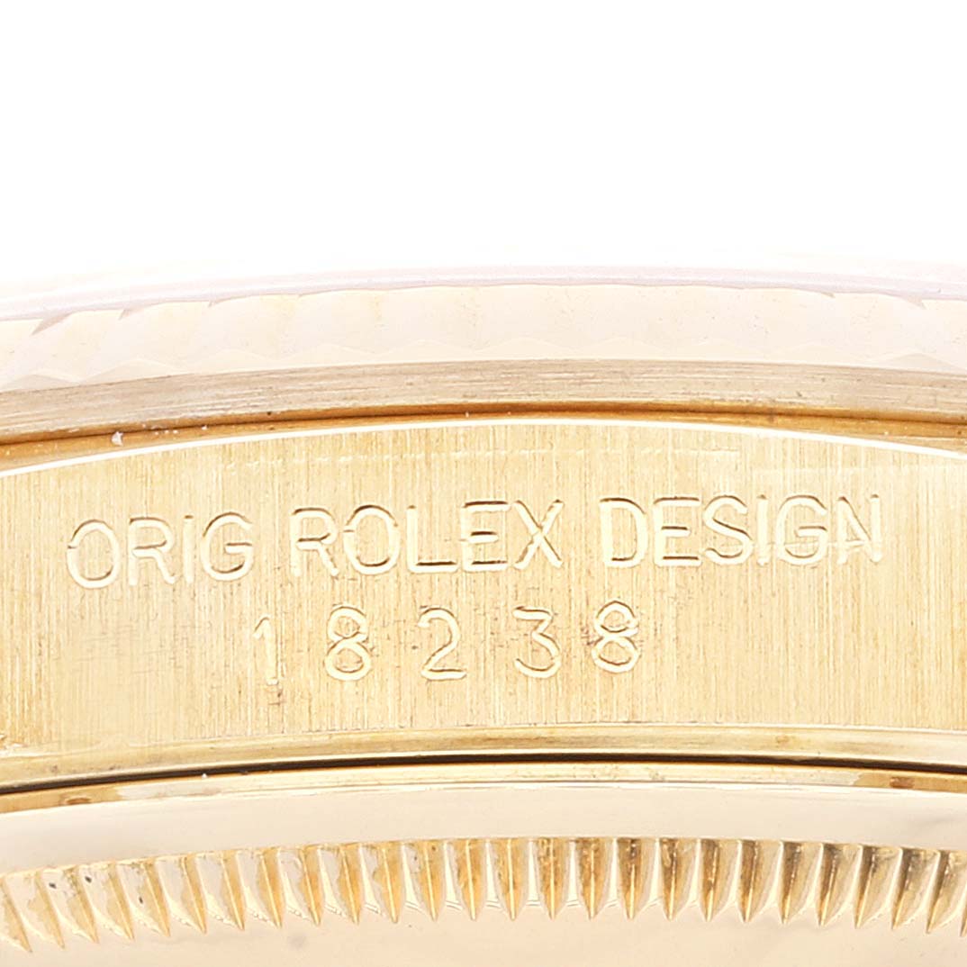 The image shows a close-up of the side of a Rolex President 18238 Men
s Yellow Gold Champagne Dial 18238 Men
s Yellow Gold Champagne Dial model, highlighting the engraved model number 18238.