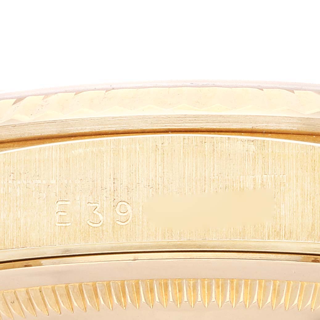 The image shows a close-up of the engraved edge of a Rolex President 18238 Men
s Yellow Gold Champagne Dial 18238 Men
s Yellow Gold Champagne Dial model watch.