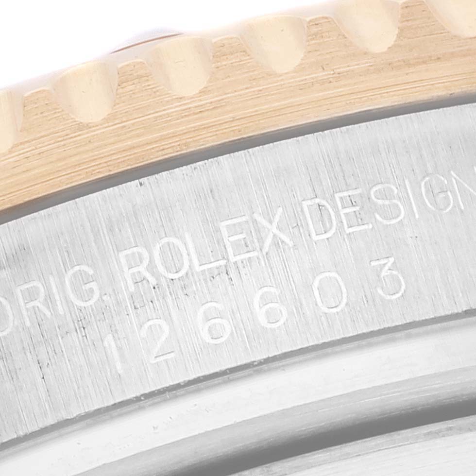 This image shows a close-up of the engraved bezel and case edge of the Rolex Sea-Dweller 126603 Men
s Steel and Gold (two tone) Black Dial 126603 Men
s Steel and Gold (two tone) Black Dial watch.