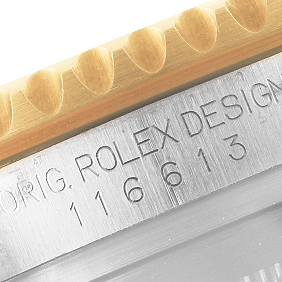 This close-up image shows the bezel edge and model number engraving on the case of a Rolex Submariner 116613 Men's Steel and Gold (two tone) Black Dial 116613 Men's Steel and Gold (two tone) Black Dial watch.