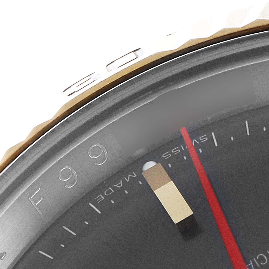 This close-up image of the Rolex Turn-o-Graph 116263 Men
s Steel and Gold (two tone) Grey Dial 116263 Men
s Steel and Gold (two tone) Grey Dial model shows the bezel, part of the dial, and the second hand.