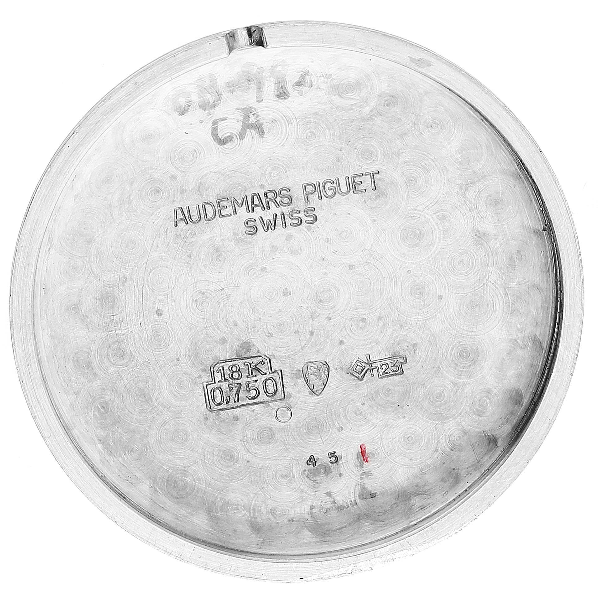 This image shows the inner case back of a vintage Audemars Piguet watch, marked with the brand, "18K 0.750" gold, and other insignia.