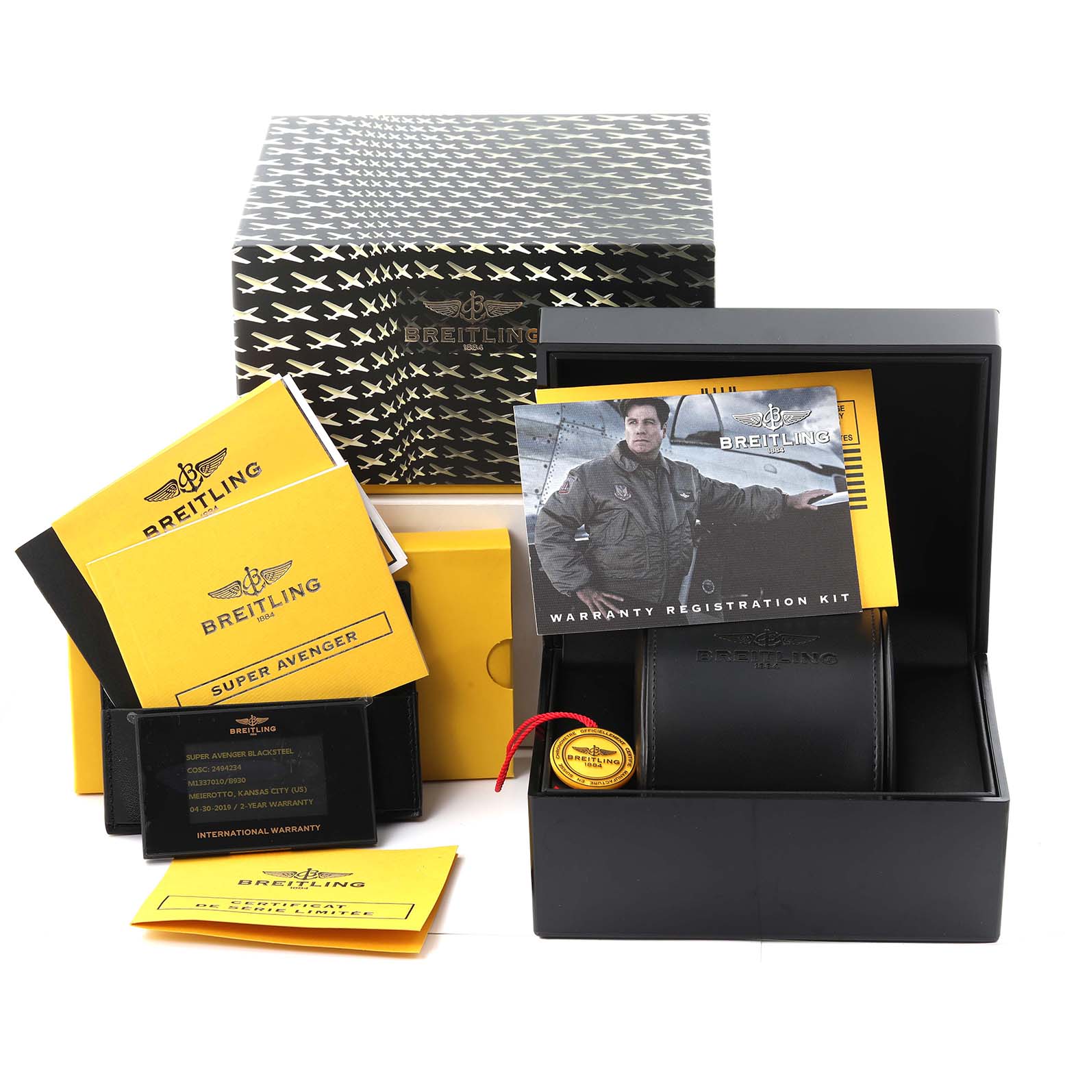 The image shows the packaging, warranty cards, registration kit, and accessories for a Breitling Limited Series Super Avenger model.