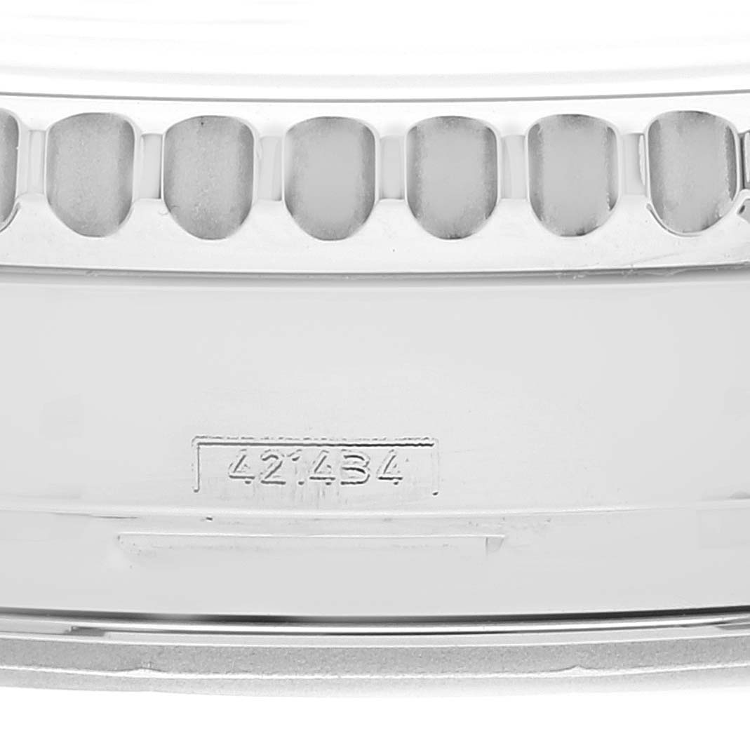 This image shows a close-up of the serial number and edge of the bezel on a Breitling Navitimer AB0120 Men's Stainless Steel Black Dial AB0120 Men's Stainless Steel Black Dial watch.