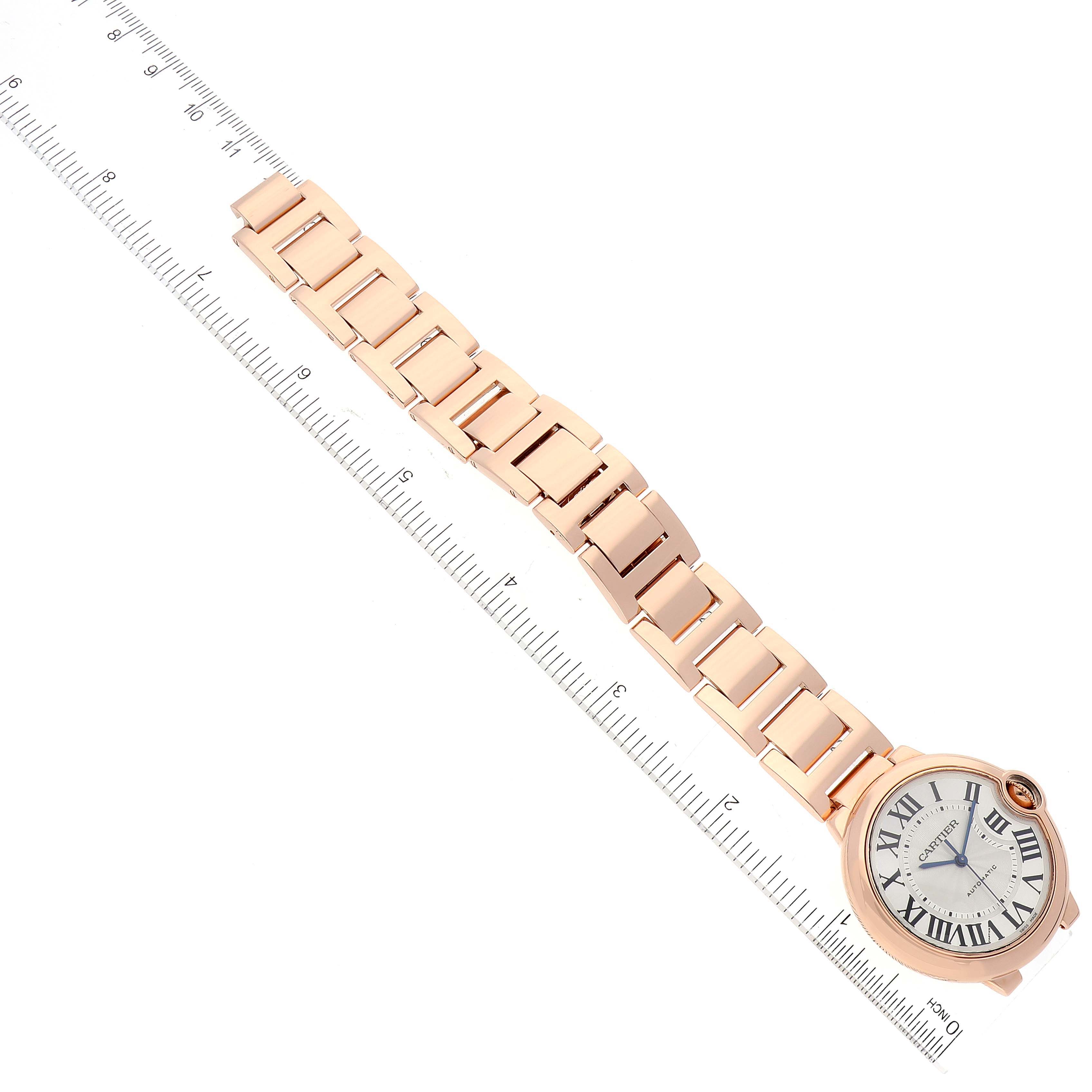 The image shows a Ballon Bleu de Cartier watch, including its face and linked bracelet, placed beside a ruler for scale.