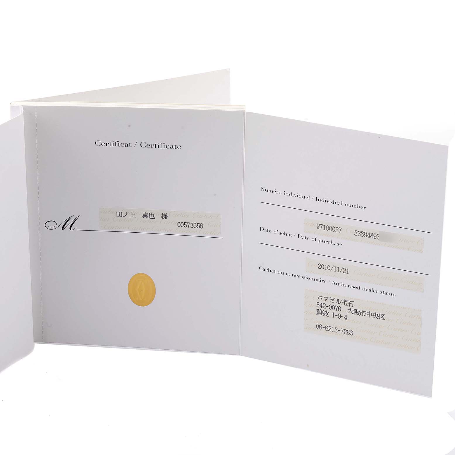 The image shows the open certificate booklet for the Calibre de Cartier model by Cartier, displaying purchase details and an authorized dealer stamp.