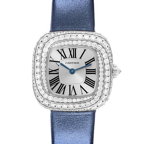 The Cartier Coussin watch is shown from the front, displaying its face with Roman numerals and a jeweled bezel along with a blue strap.