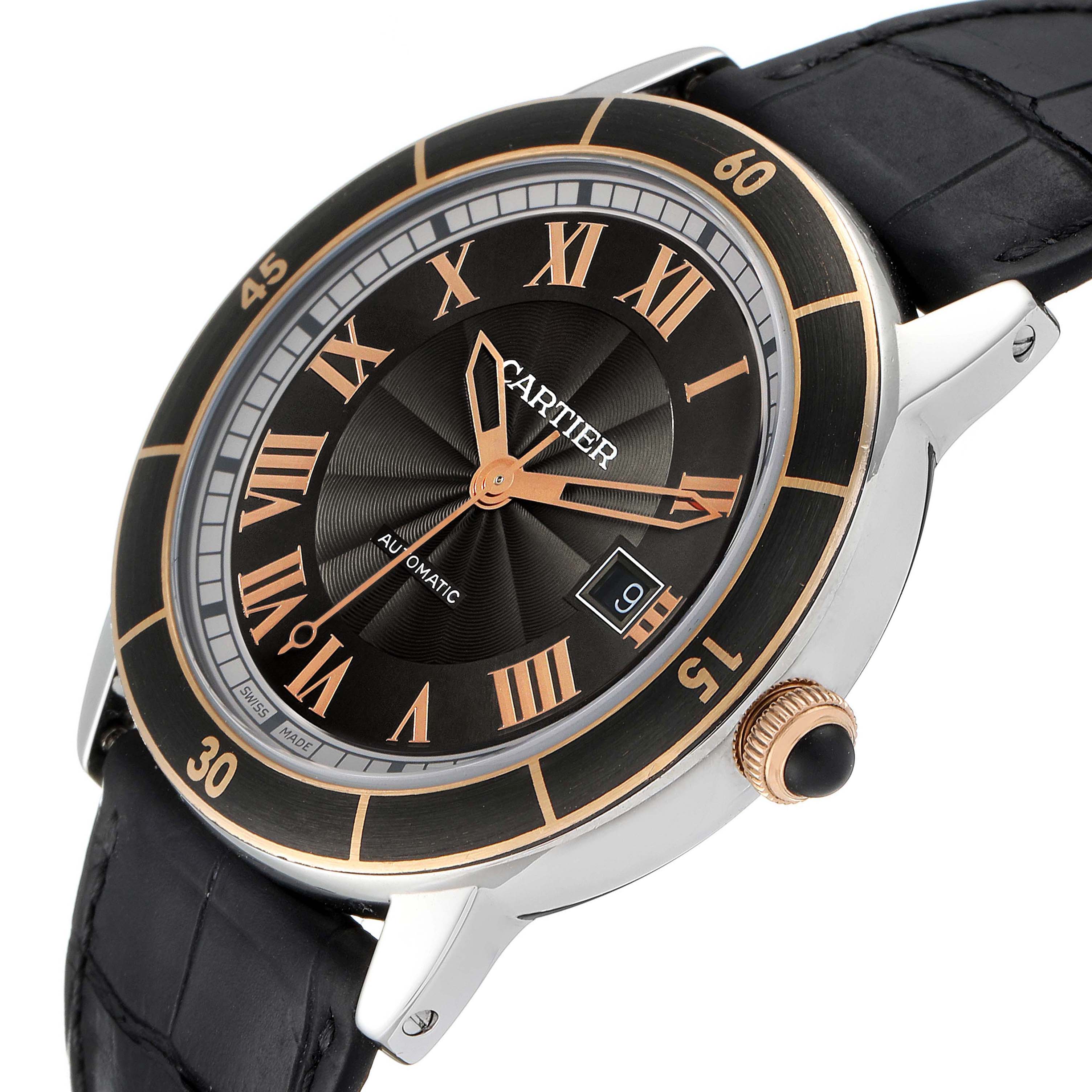 The Cartier Ronde W2RN0005 Men's Steel and Gold (two tone) Grey Dial W2RN0005 Men's Steel and Gold (two tone) Grey Dial watch is shown at an angled view highlighting the black dial, gold Roman numerals, date display, and black strap.