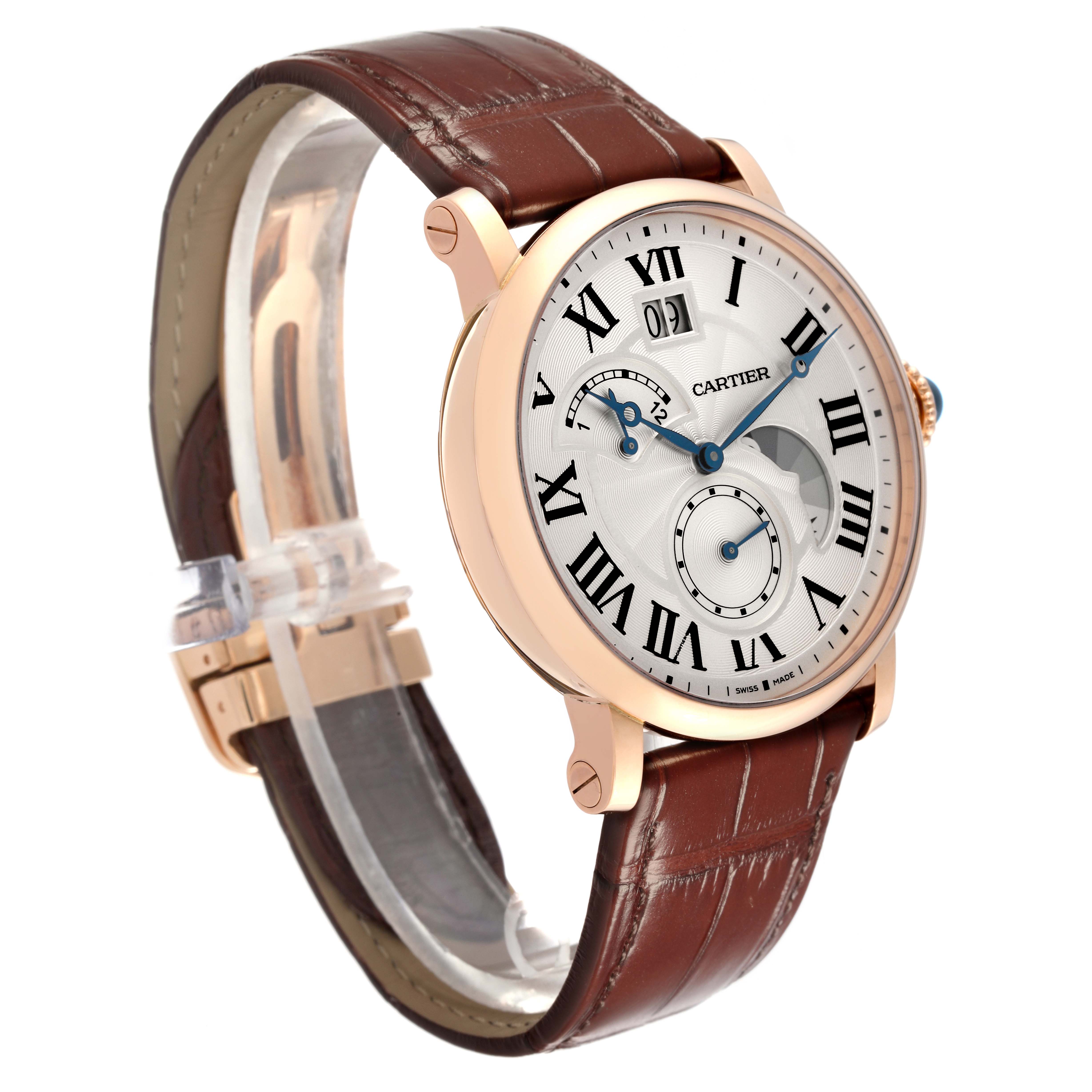The image shows a side angle of the Cartier Rotonde W1556240 Men
s Rose Gold Silver Dial W1556240 Men
s Rose Gold Silver Dial watch, highlighting its brown leather strap and detailed face with Roman numerals.