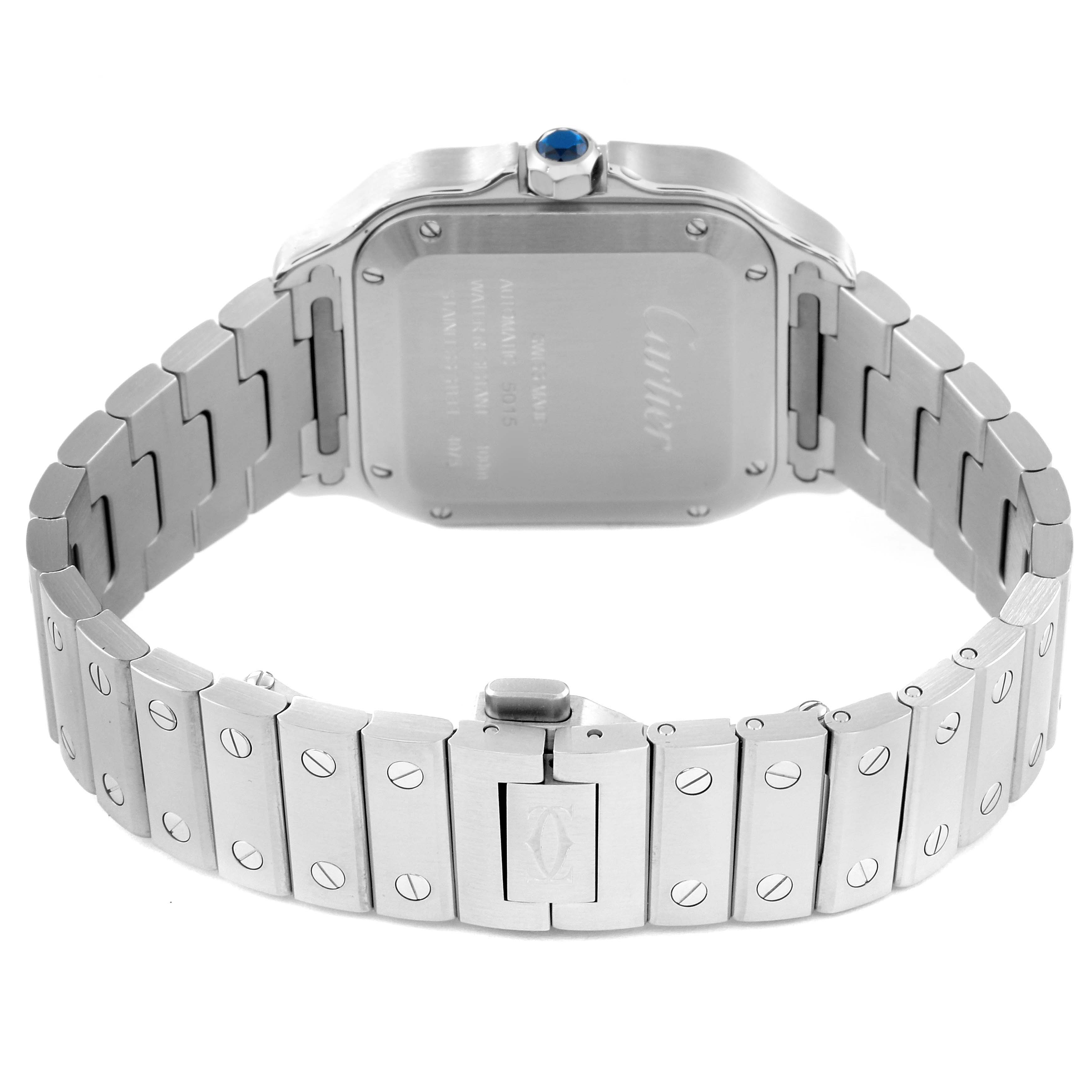 The image shows the back and bracelet of a Santos model watch by Cartier, highlighting the clasp and caseback details.