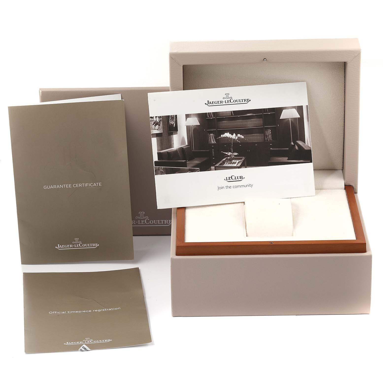 This image shows the packaging, guarantee certificate, and registration documents for the Jaeger-LeCoultre Reverso watch.