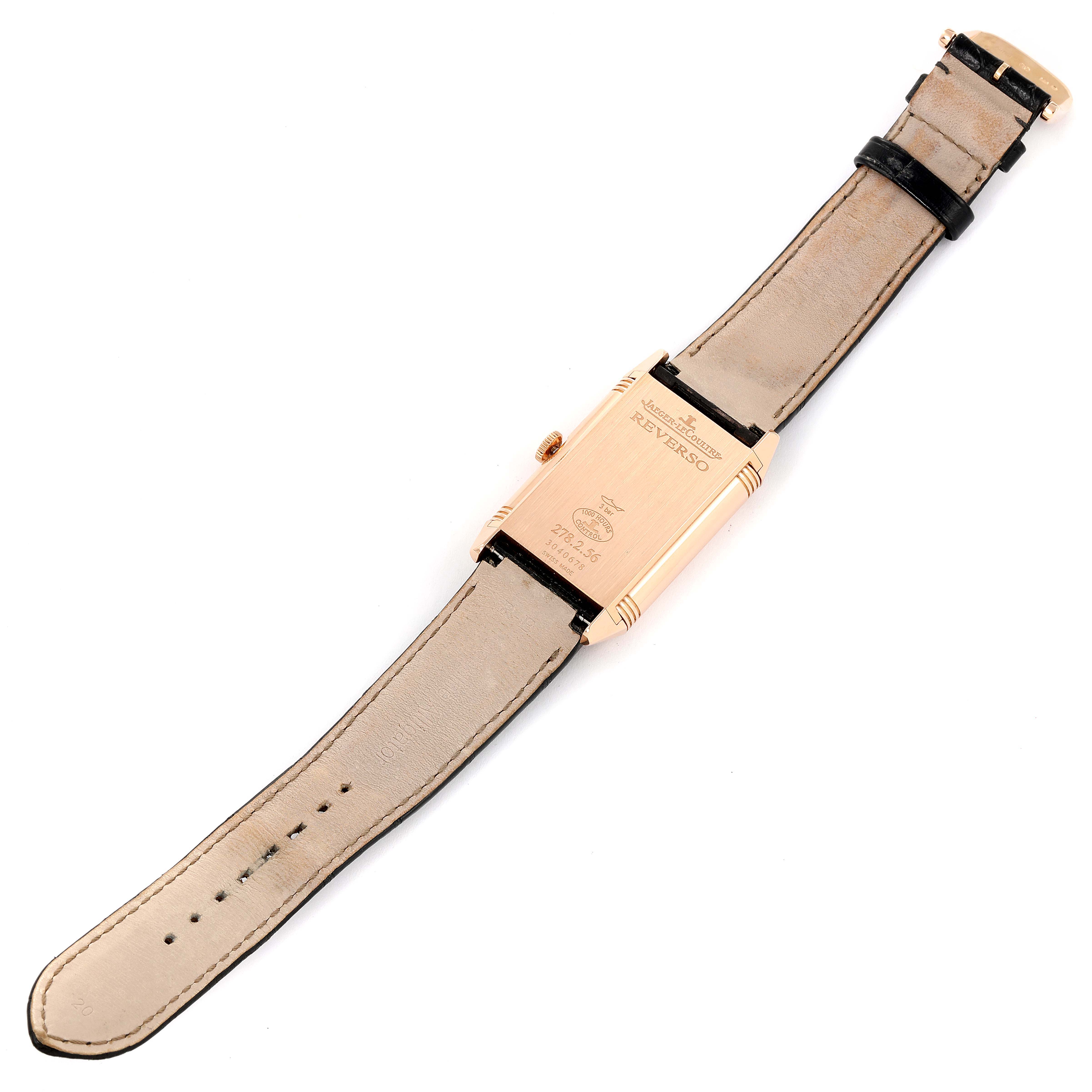 This image shows the back of a Jaeger-LeCoultre Reverso watch, including its case back and leather straps.