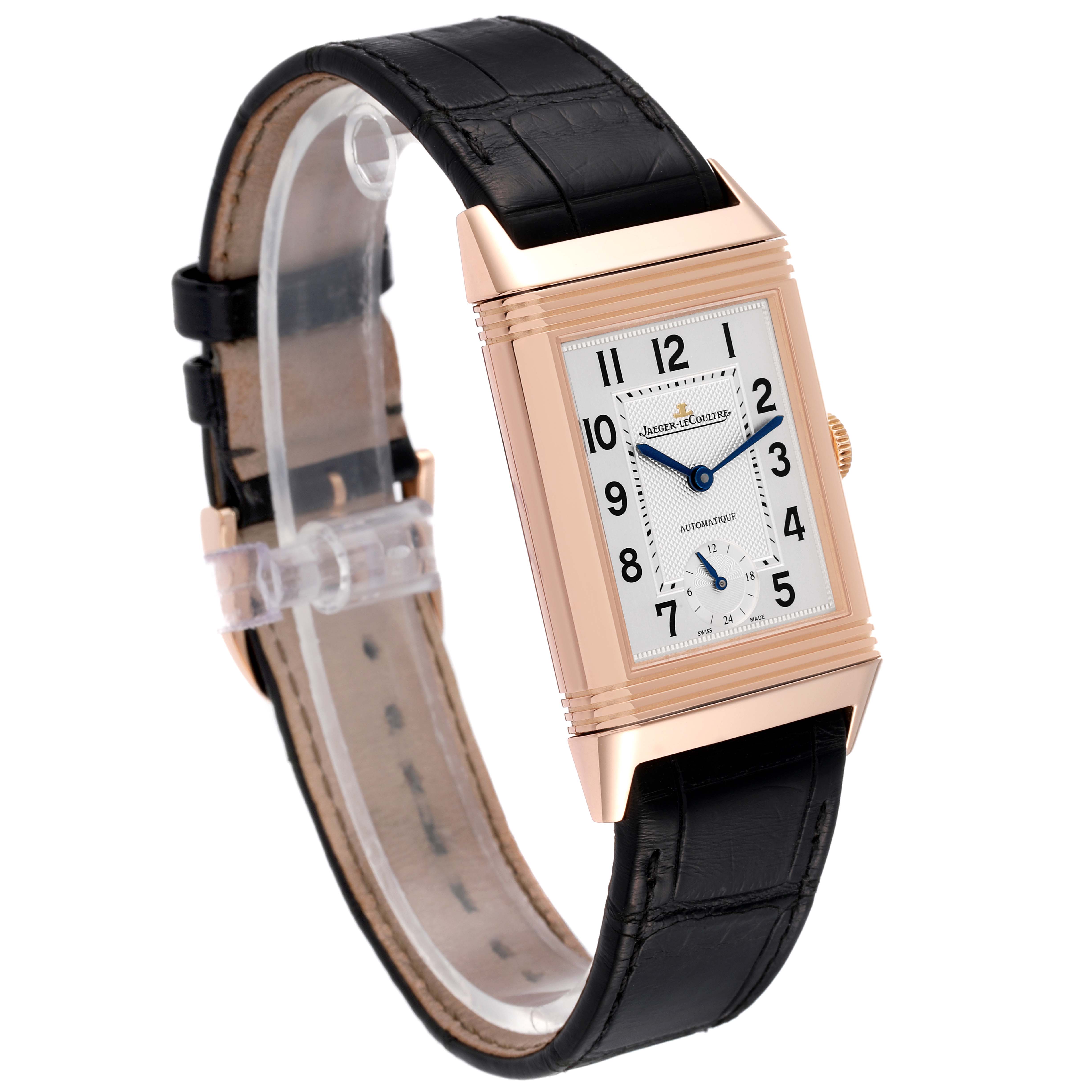 The Jaeger LeCoultre Reverso Q3802520 Men's Rose Gold Silver Dial Q3802520 Men's Rose Gold Silver Dial watch is shown from an angled front view, highlighting the rectangular face, black leather strap, and gold case.