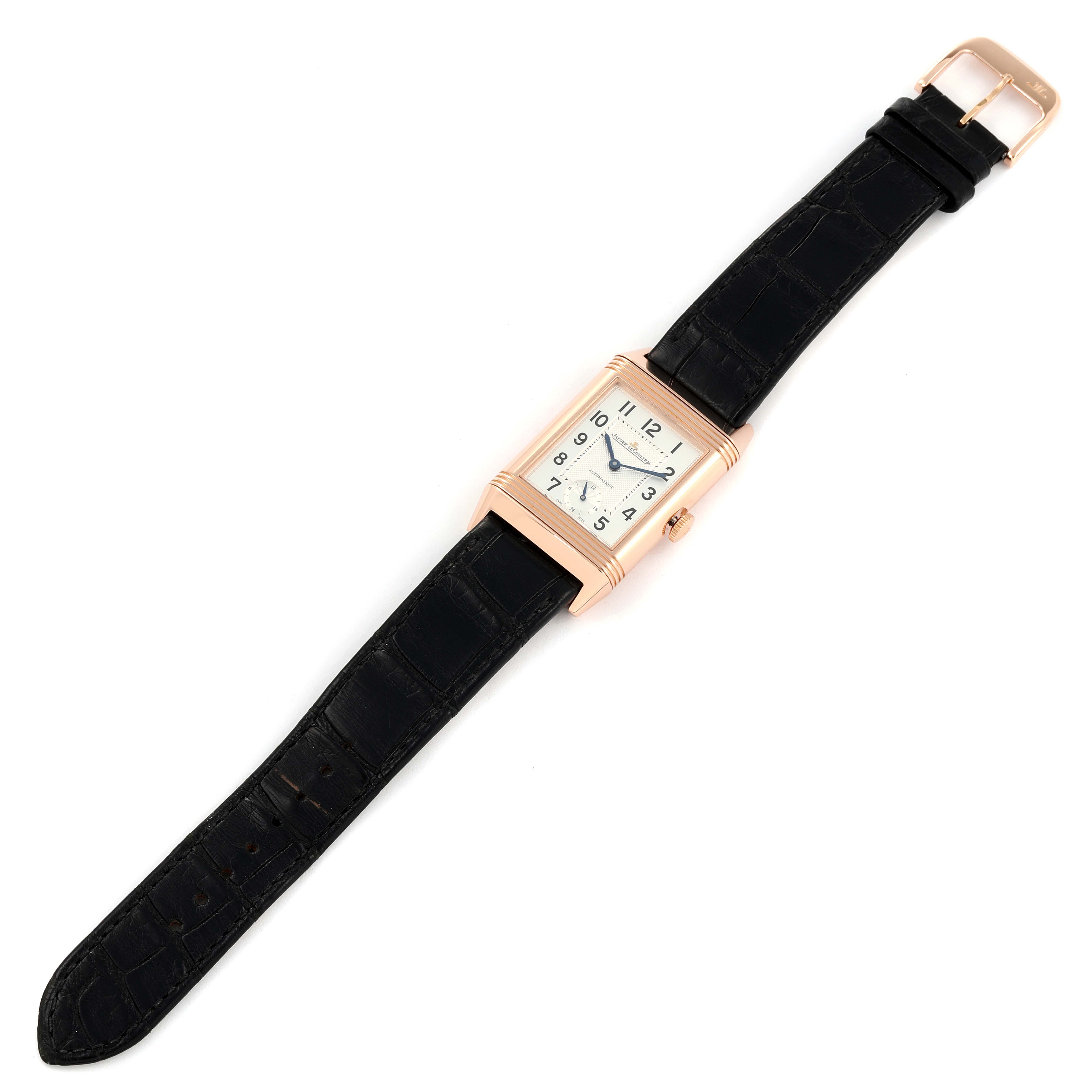 The image shows a Jaeger LeCoultre Reverso Q3802520 Men's Rose Gold Silver Dial Q3802520 Men's Rose Gold Silver Dial watch laid flat, displaying its face, strap, and buckle.