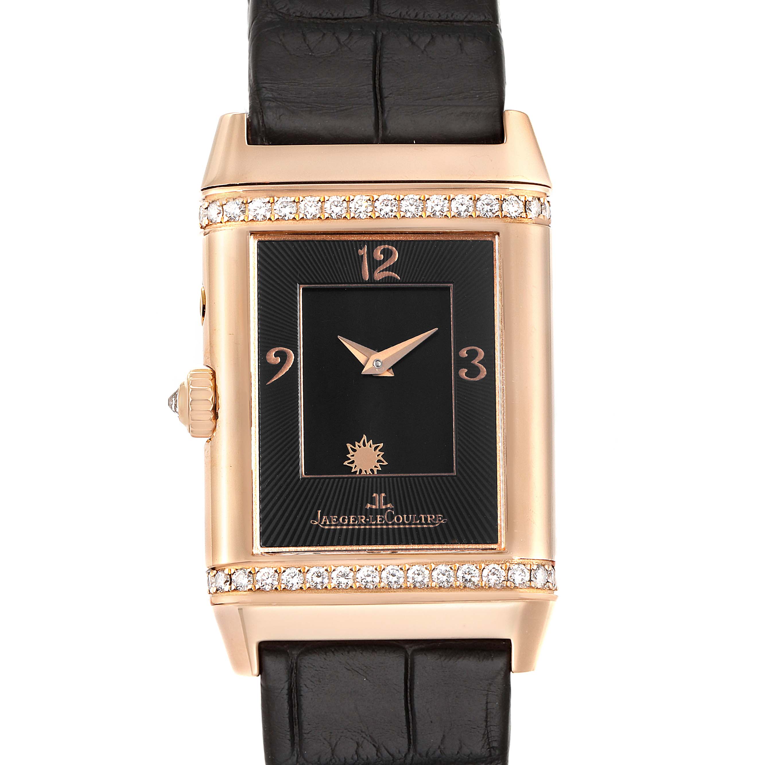 The image shows a front view of a Jaeger-LeCoultre Reverso watch with a black dial, gold case, diamond accents, and black leather strap.