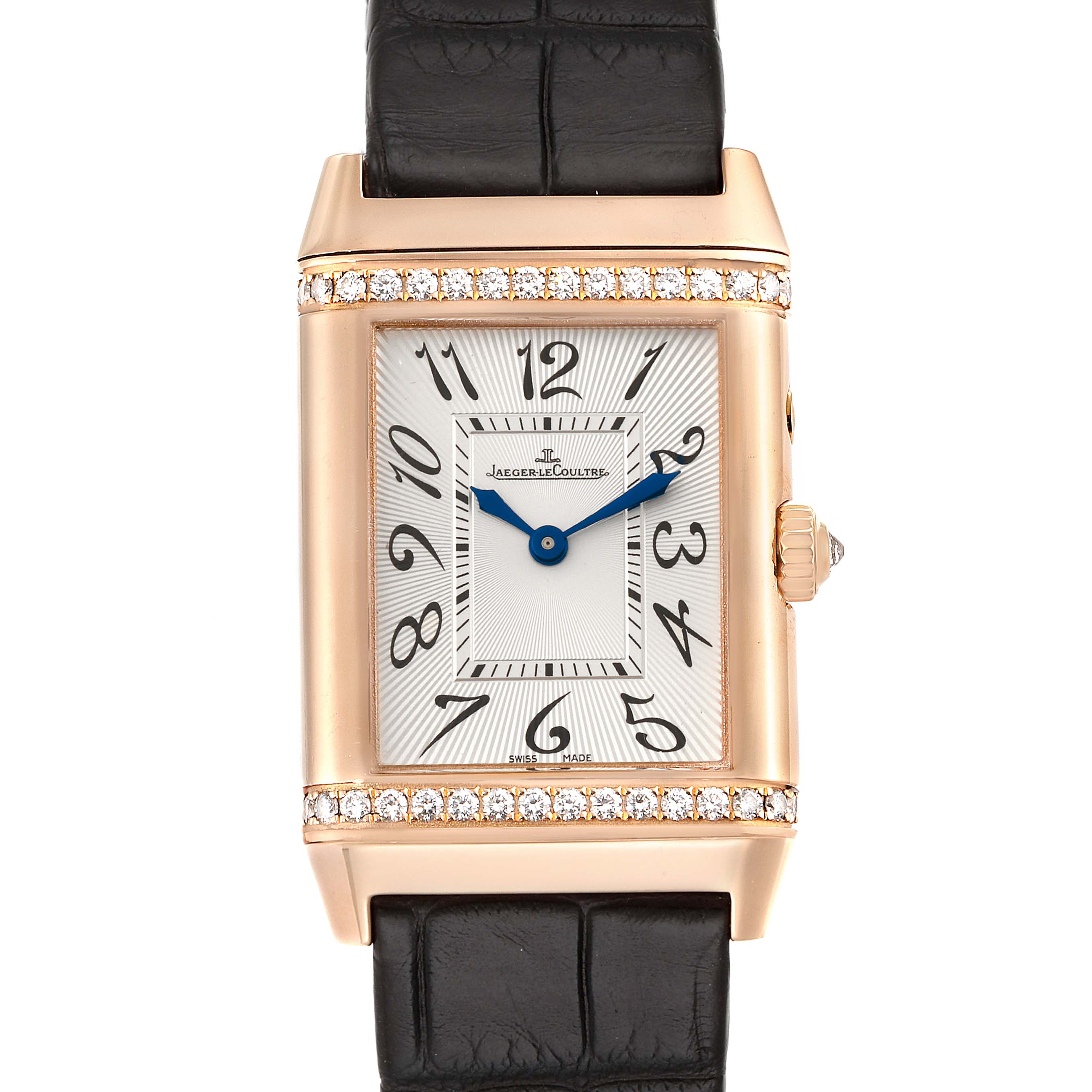 The image shows a front view of the Jaeger-LeCoultre Reverso watch, featuring a rectangular face, black leather strap, and a gold case adorned with diamonds.