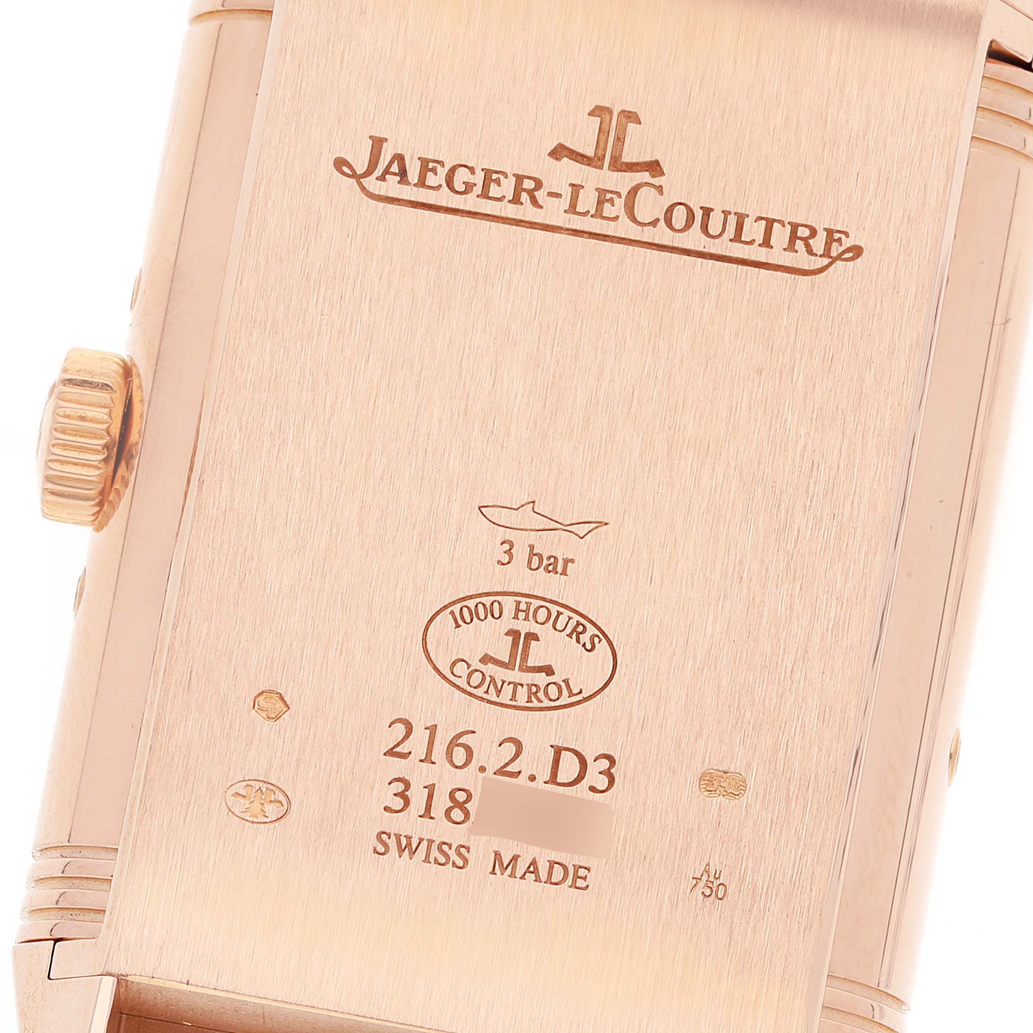 The image shows the back of the Jaeger-LeCoultre Reverso watch, highlighting the engravings and the side view of the crown.