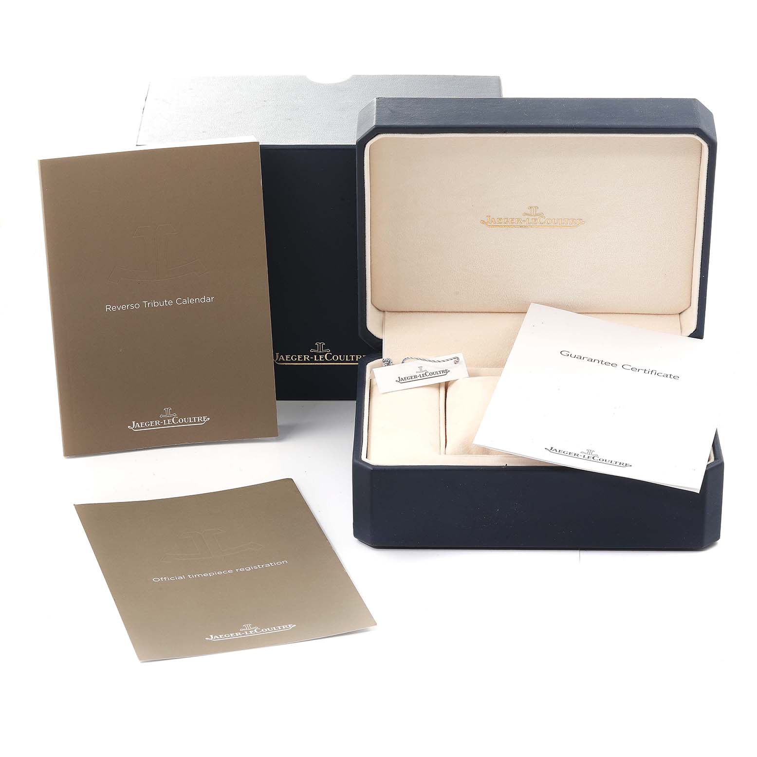 The image shows the packaging and booklets for a Jaeger-LeCoultre Reverso model with a box, guarantee certificate, and manuals.