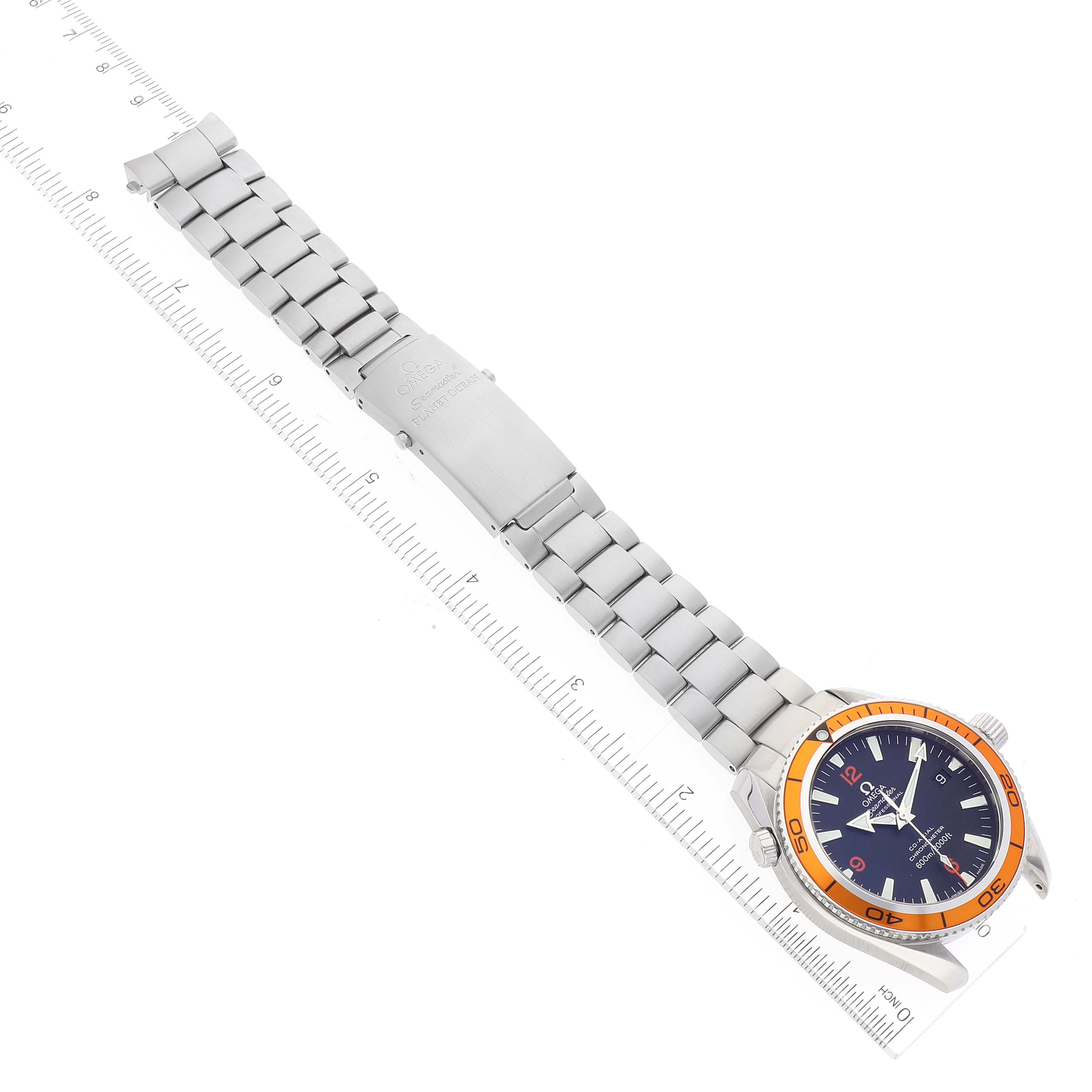 The image shows the full stainless steel bracelet and face of the Omega Planet Ocean 2209.50.00 Men's Stainless Steel Black Dial 2209.50.00 Men's Stainless Steel Black Dial watch, laid flat against a ruler.