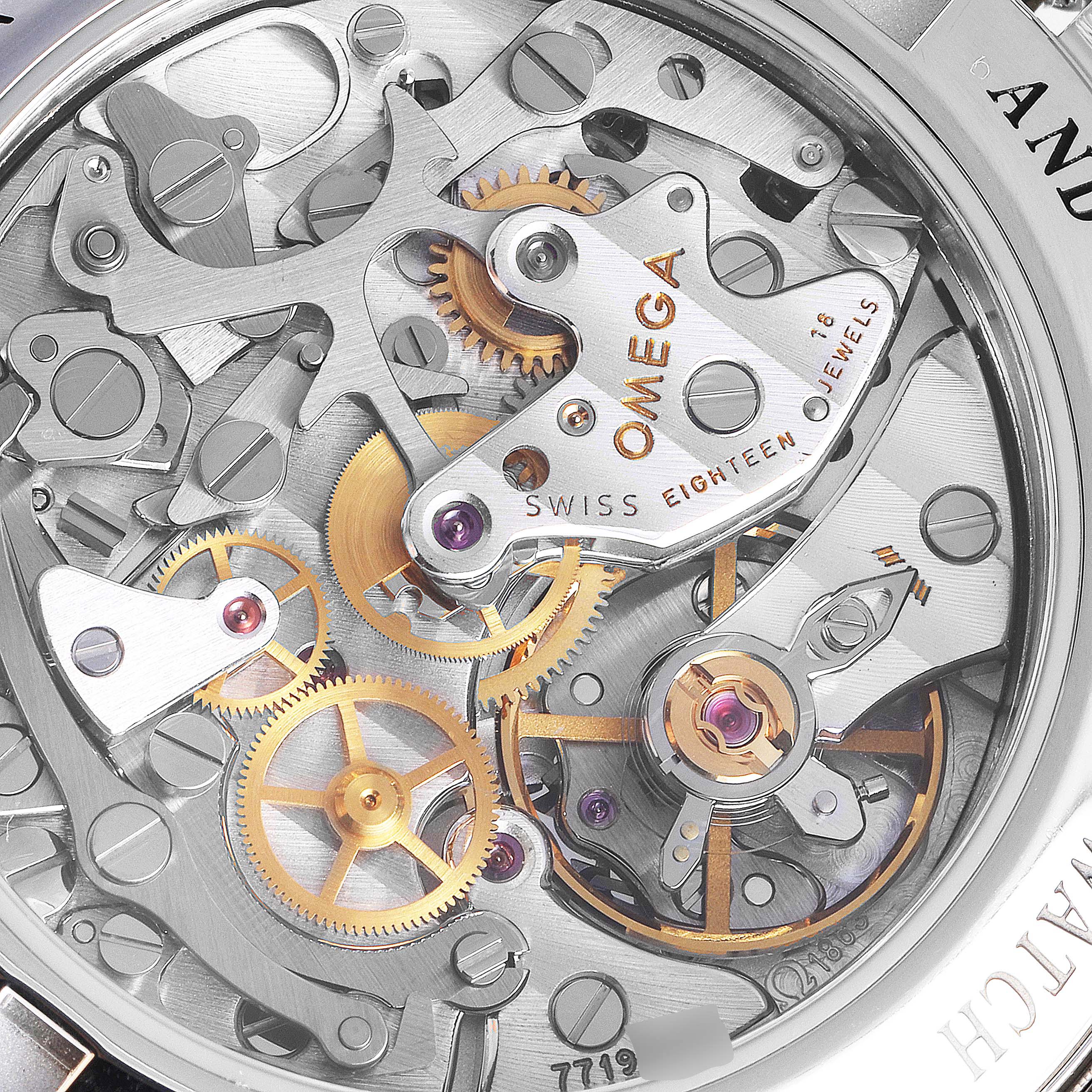 The image shows a close-up view of the Omega Speedmaster 311.30.42.30.13.001 Men's Stainless Steel Brown Dial 311.30.42.30.13.001 Men's Stainless Steel Brown Dial watch’s intricate movement and gears through the case back.