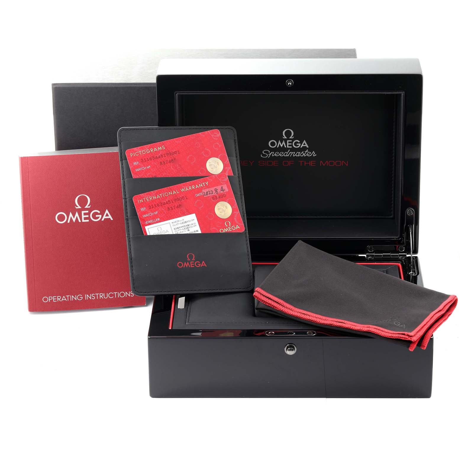 The image shows an Omega Speedmaster 311.63.44.51.99.001 Men's Stainless Steel Grey Dial 311.63.44.51.99.001 Men's Stainless Steel Grey Dial watch box, warranty cards, instruction booklet, and a cleaning cloth.