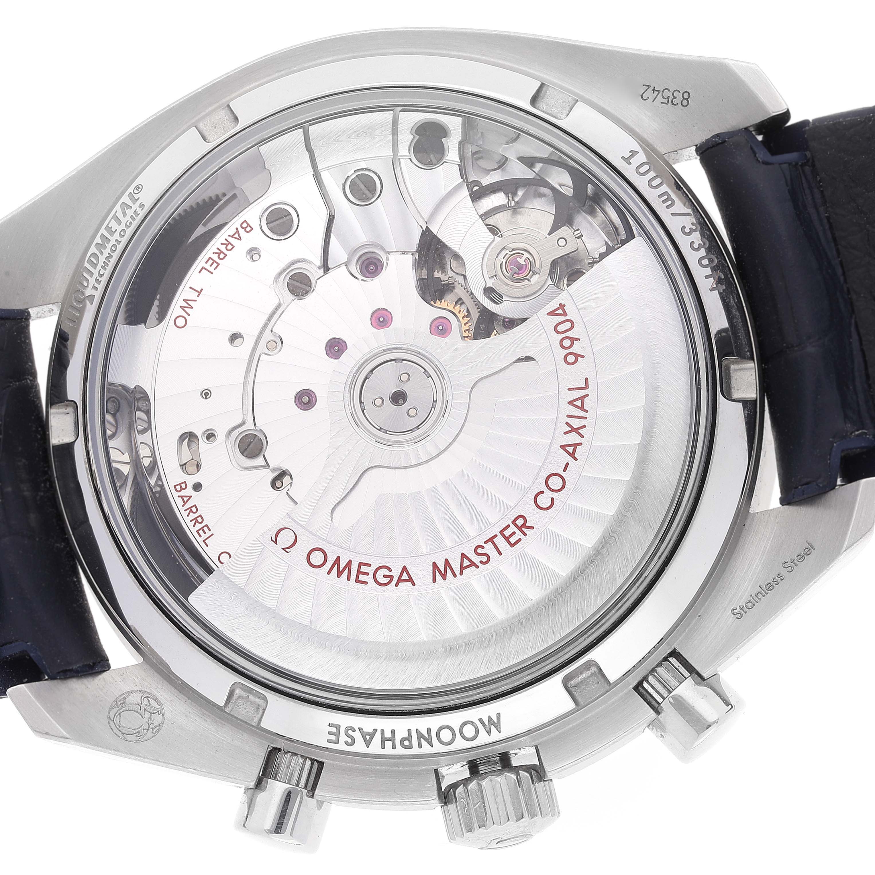 The image shows the back view of the Omega Speedmaster 304.33.44.52.03.001 Men's Stainless Steel Blue Dial 304.33.44.52.03.001 Men's Stainless Steel Blue Dial watch, highlighting its movement and internal mechanics.