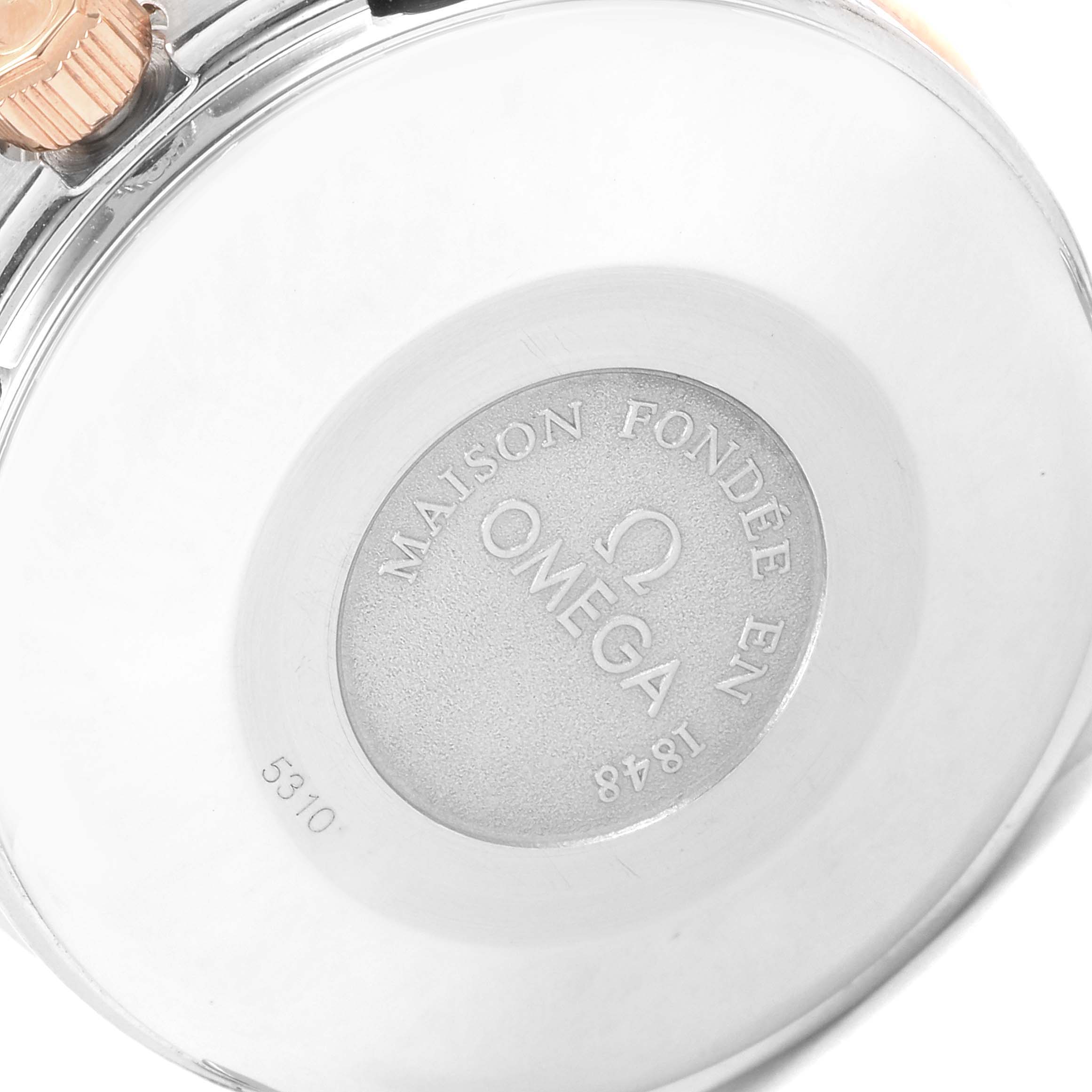 The image shows the backside of an Omega Speedmaster Men's Steel and Gold (two tone) White Dial Men's Steel and Gold (two tone) White Dial watch, highlighting the engraved brand logo and limited edition number.