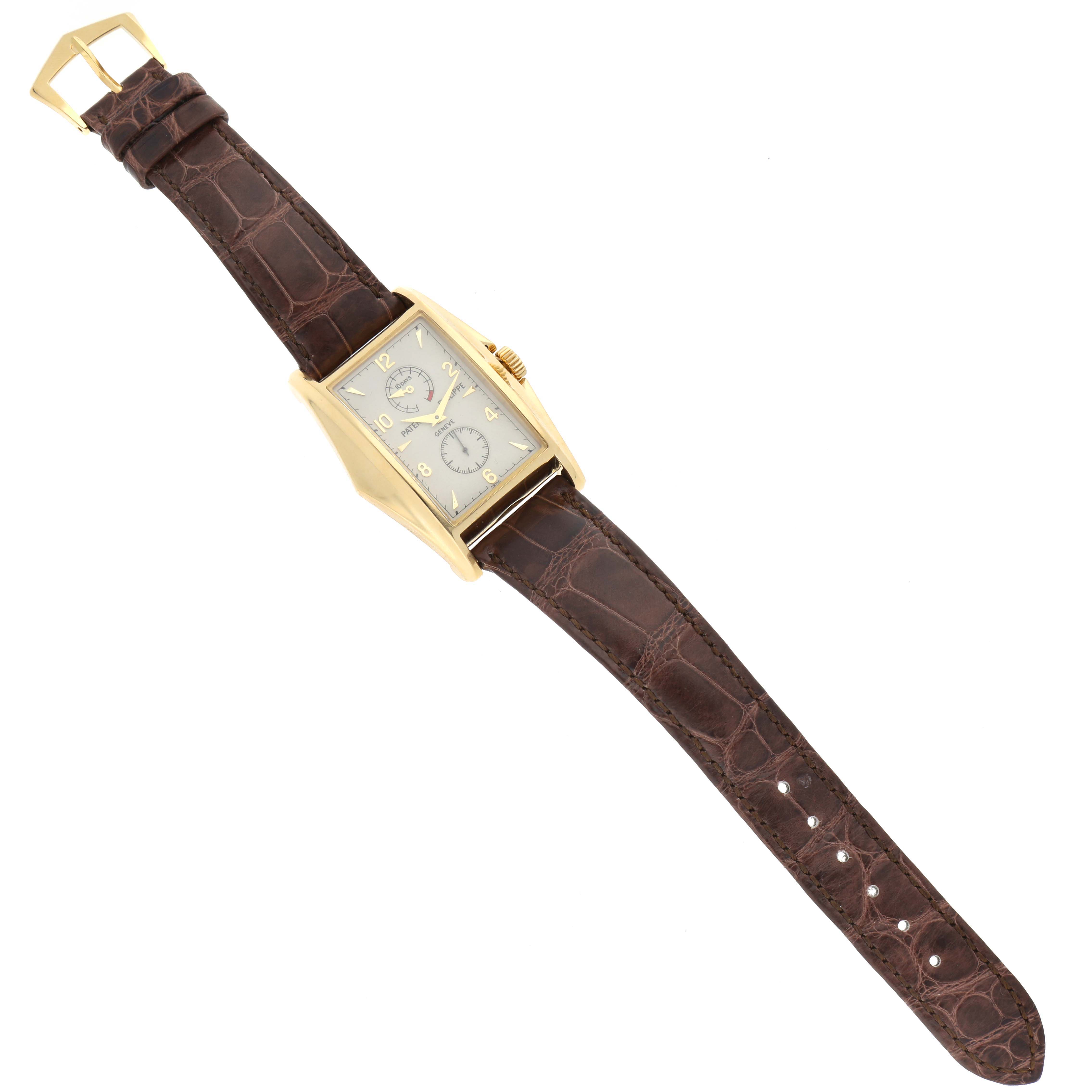 The image shows a top-down view of the Patek Philippe Gondolo 5100J -001 Men's Yellow Gold Silver Dial 5100J -001 Men's Yellow Gold Silver Dial watch, highlighting the dial, case, crown, and leather strap.