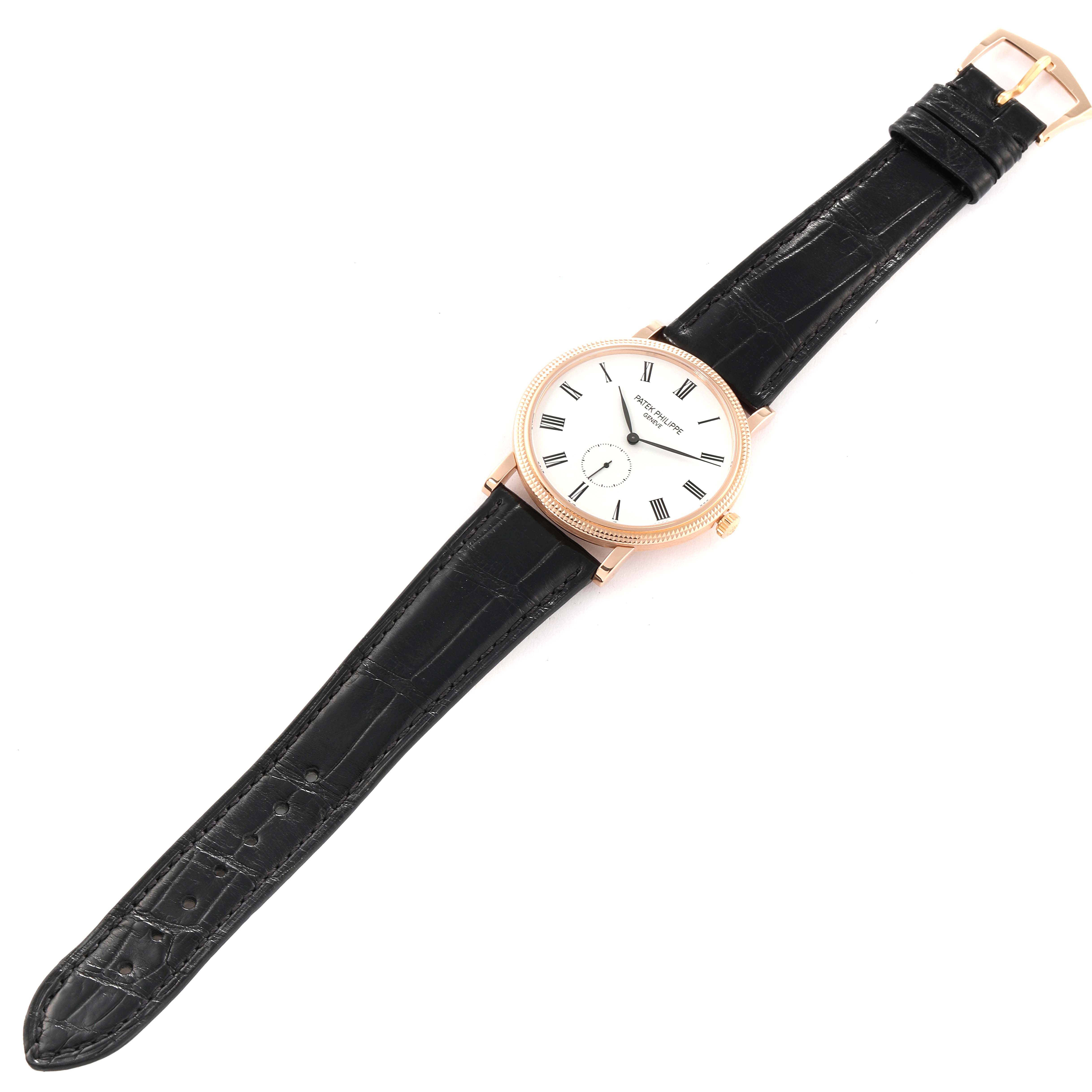 The Patek Philippe Calatrava 5119R Men's Rose Gold White Dial 5119R Men's Rose Gold White Dial watch is shown from a top view, displaying its face, hands, case, and black leather strap.