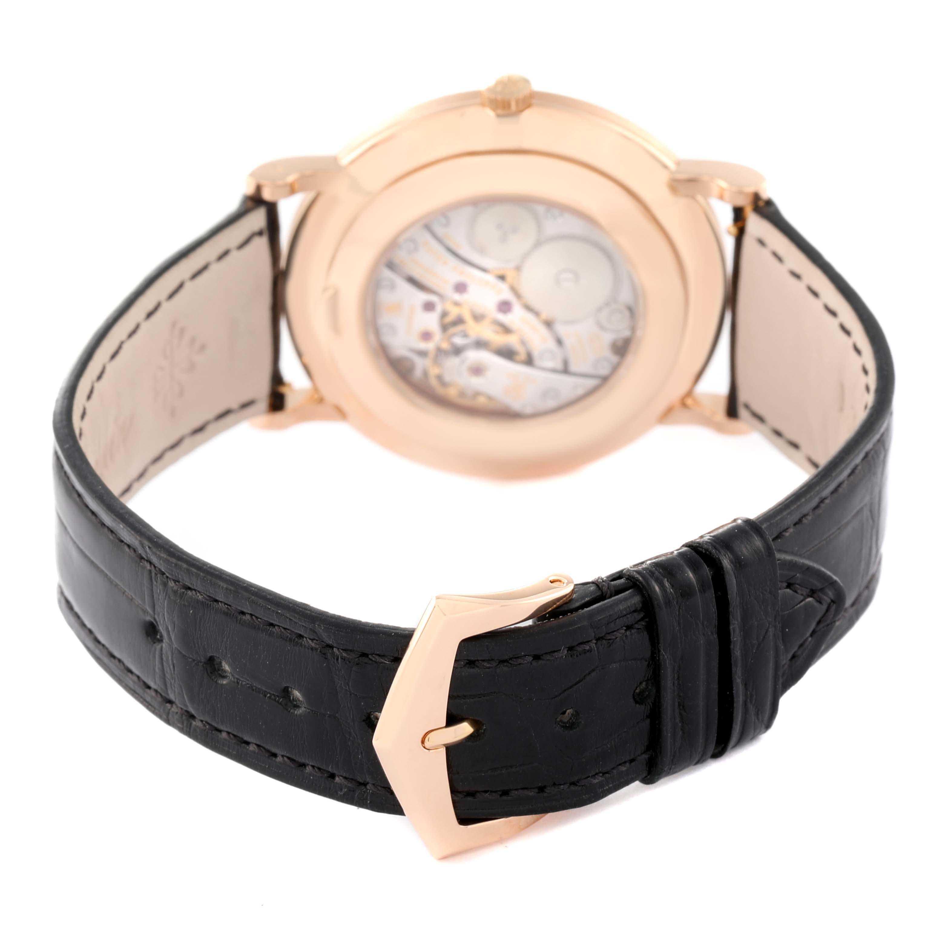The image shows the back view of a Patek Philippe Calatrava 5119R Men's Rose Gold White Dial 5119R Men's Rose Gold White Dial watch, displaying the movement and leather strap with a buckle.