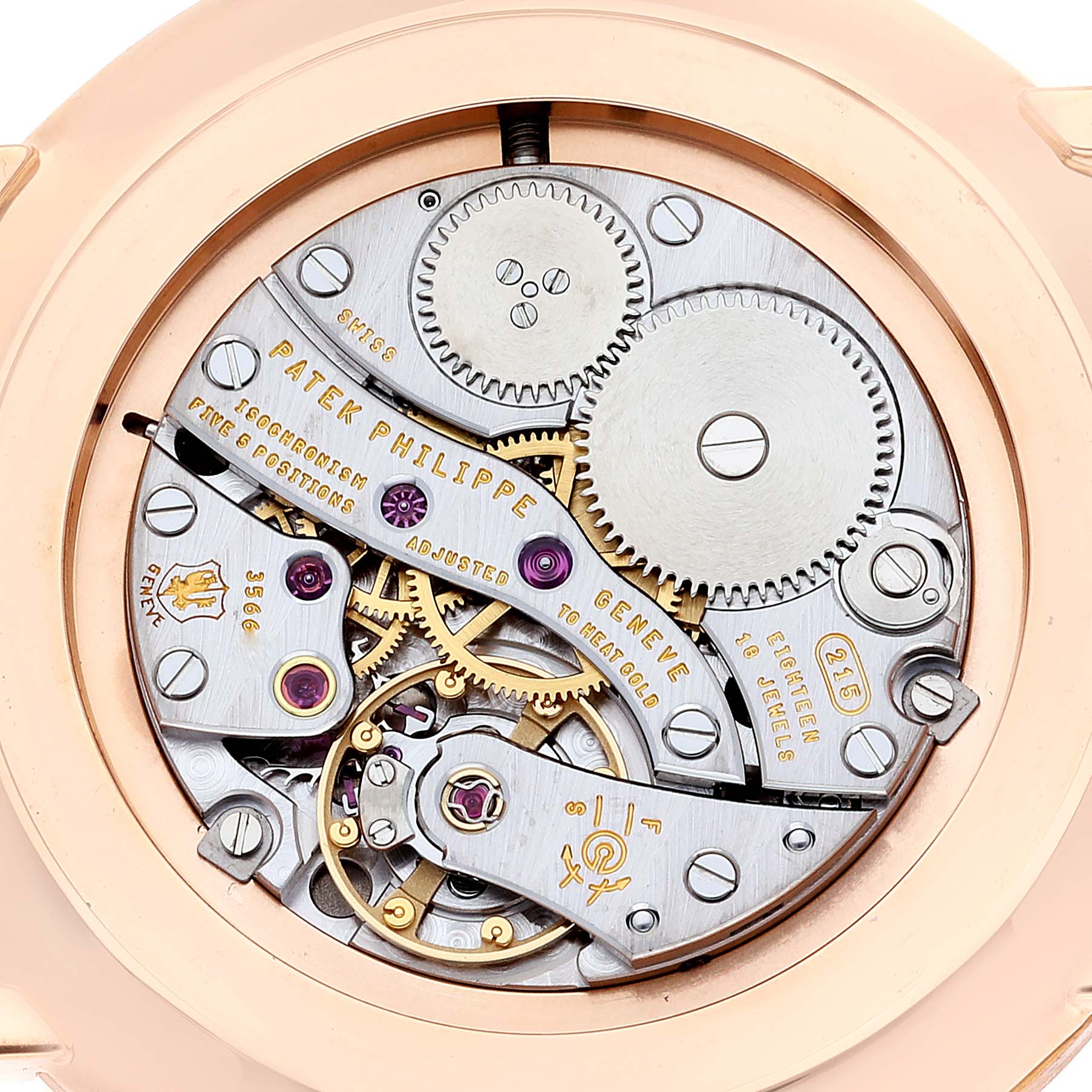 This image shows the intricate inner mechanism of the Patek Philippe Calatrava 5119R Men's Rose Gold White Dial 5119R Men's Rose Gold White Dial watch from a rear angle, highlighting its gears and components.