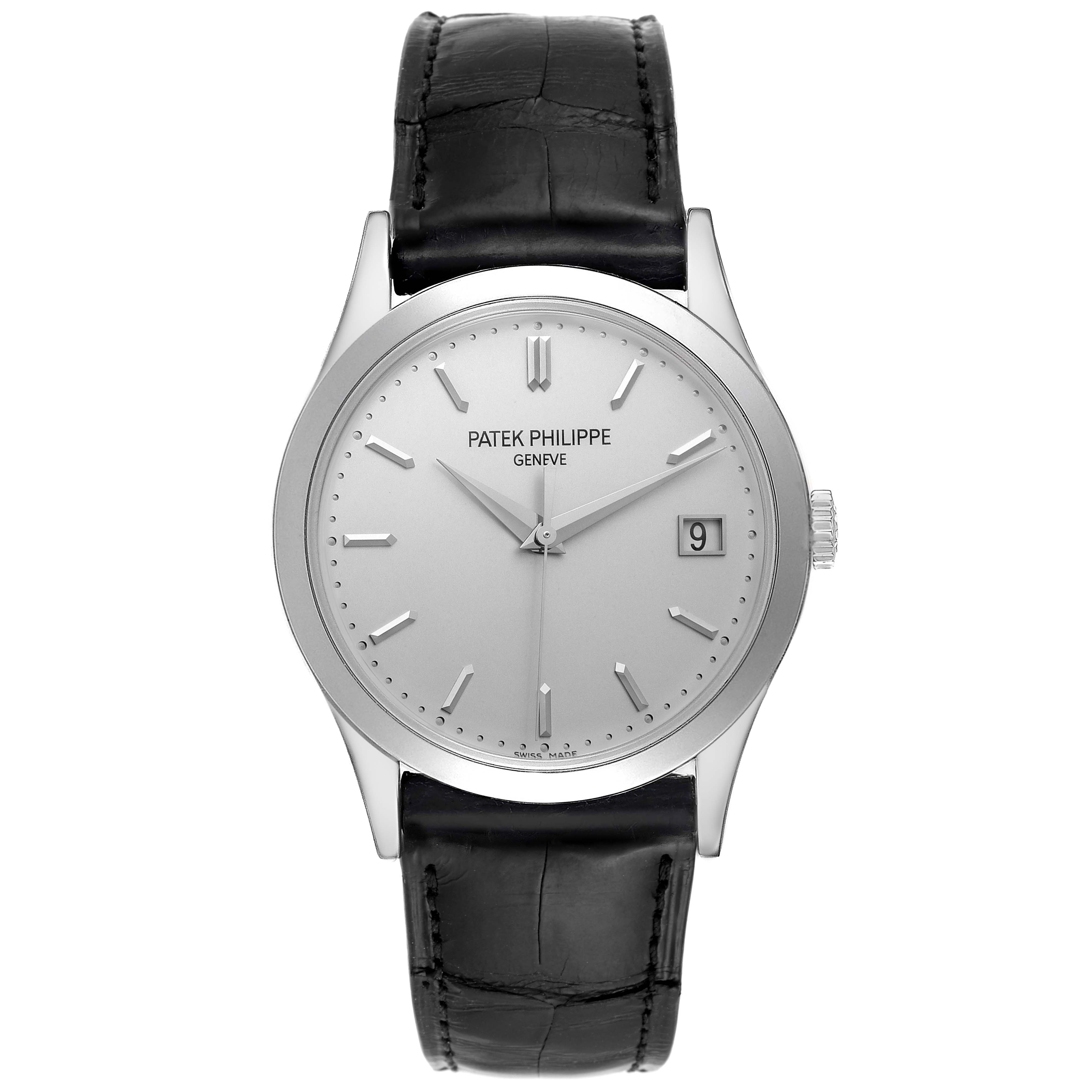 The image shows a front view of a Patek Philippe Calatrava 5296G-010 Men's White Gold Silver Dial 5296G-010 Men's White Gold Silver Dial watch with a black leather strap, silver dial, and date display.