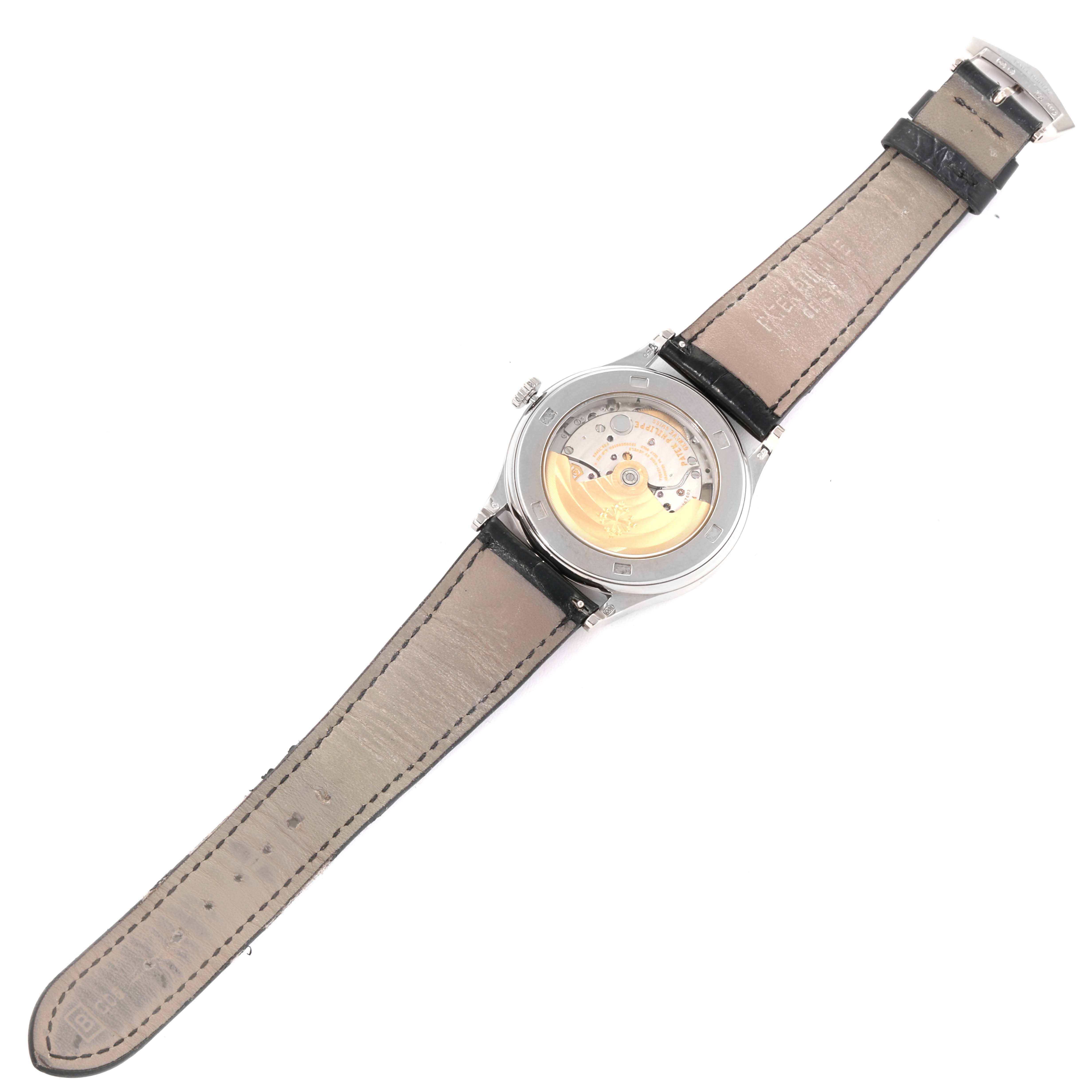 This image shows the backside of a Patek Philippe Calatrava 5296G-010 Men's White Gold Silver Dial 5296G-010 Men's White Gold Silver Dial watch, displaying its movement and leather strap.