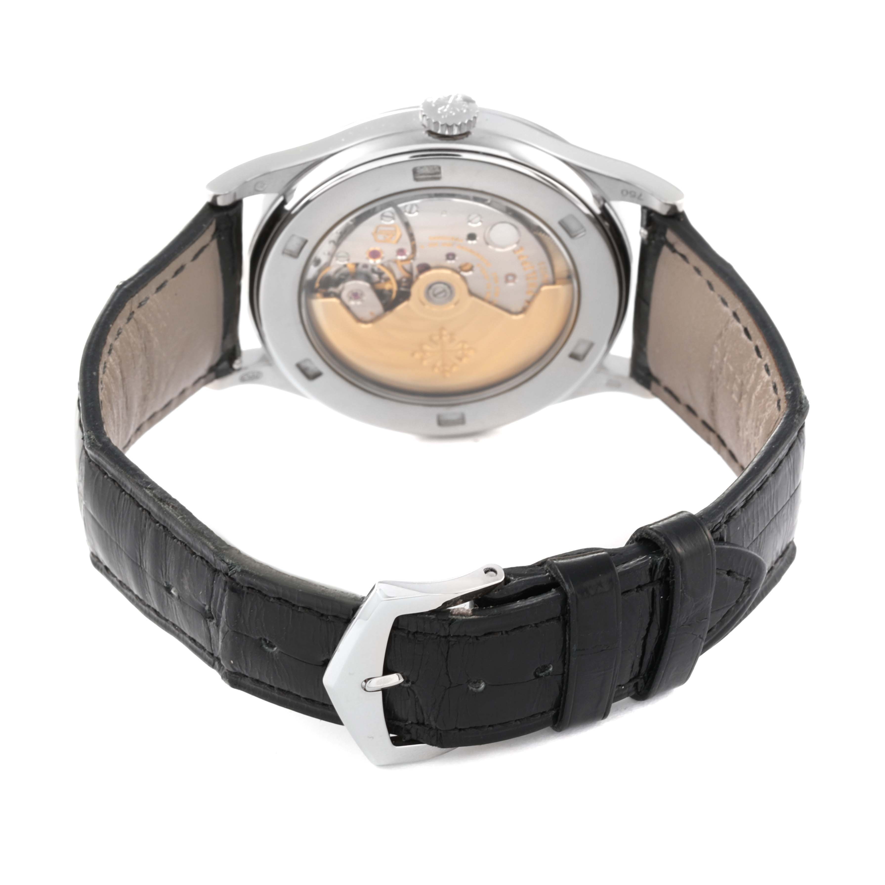 The image shows the rear view of the Patek Philippe Calatrava 5296G-010 Men's White Gold Silver Dial 5296G-010 Men's White Gold Silver Dial watch, highlighting its movement and black leather strap.