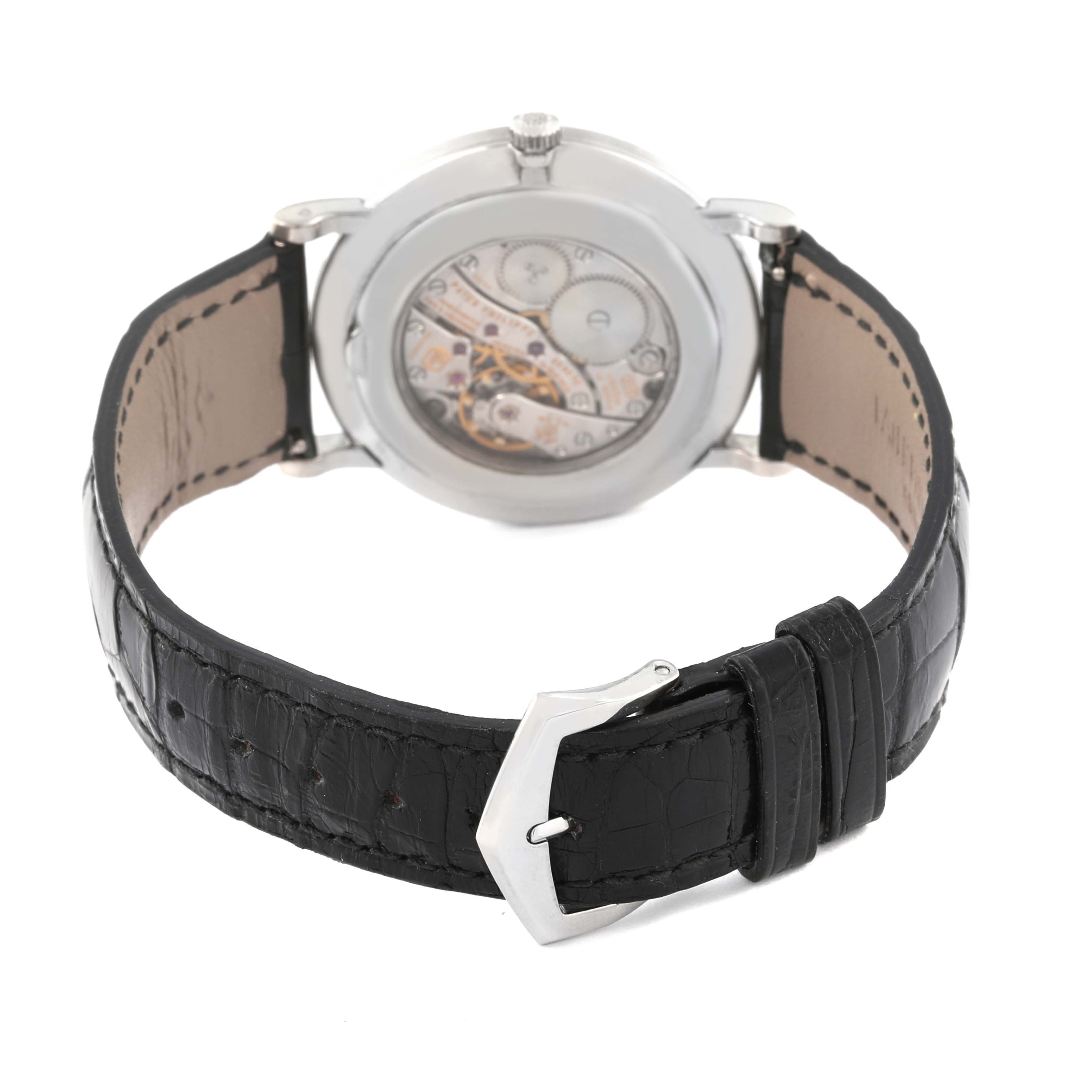 This image shows the back view of a Patek Philippe Calatrava 5116G Men
s White Gold White Dial 5116G Men
s White Gold White Dial watch, highlighting the movement and leather strap with a buckle.