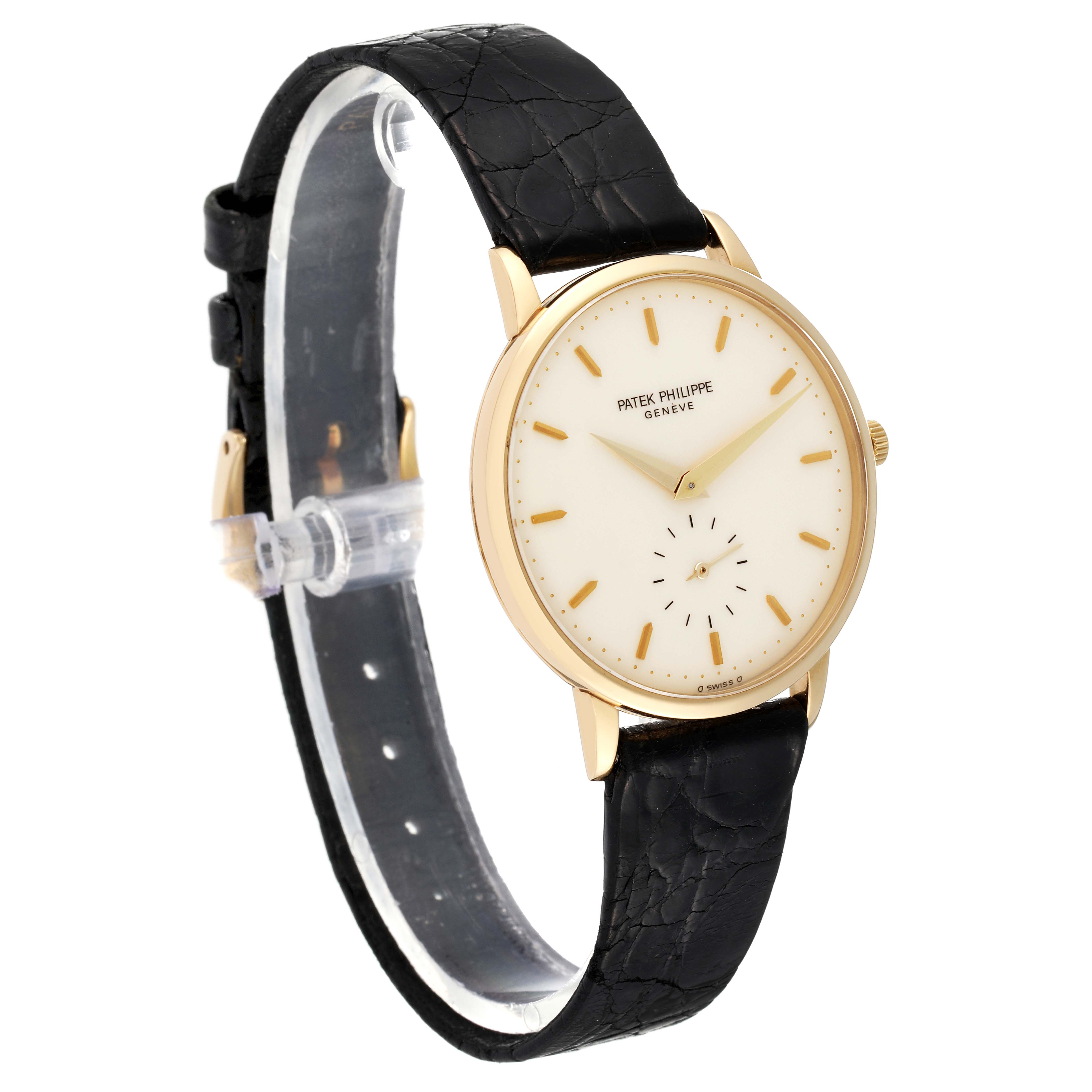 This image shows a Patek Philippe Calatrava 3893/1 Men's Yellow Gold White Dial 3893/1 Men's Yellow Gold White Dial watch, angled to display the dial, gold case, and black leather strap.