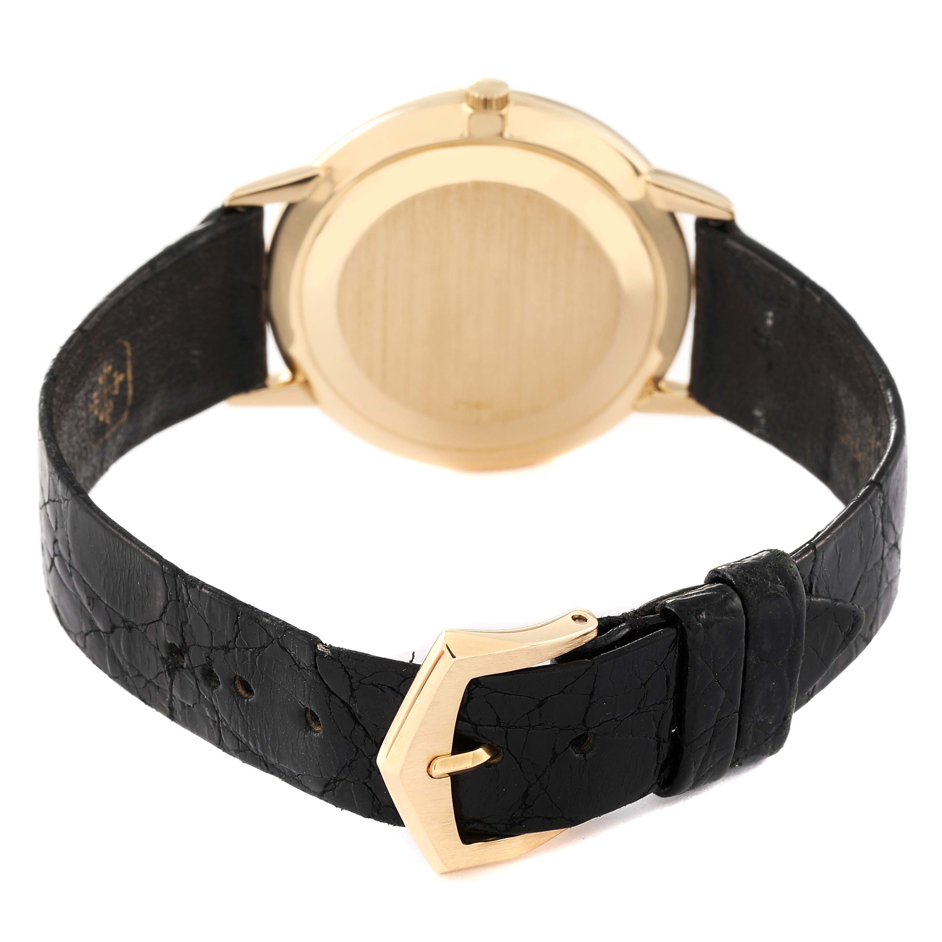 This image shows the back view of a Patek Philippe Calatrava 3893/1 Men's Yellow Gold White Dial 3893/1 Men's Yellow Gold White Dial watch, focusing on the case back, crown, leather strap, and buckle.