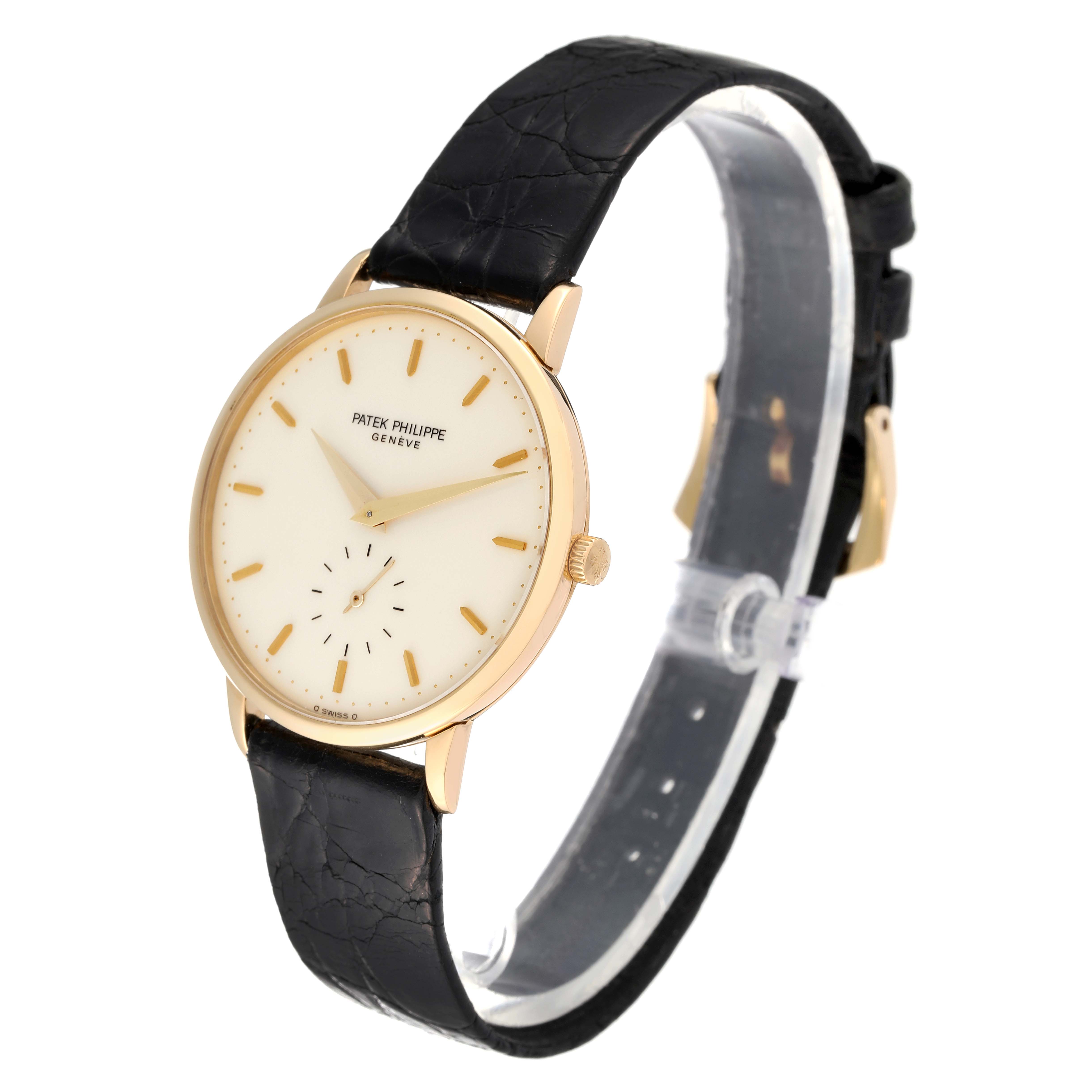 This image shows a side angle of a Patek Philippe Calatrava 3893/1 Men's Yellow Gold White Dial 3893/1 Men's Yellow Gold White Dial model watch, highlighting the dial, leather strap, and crown.