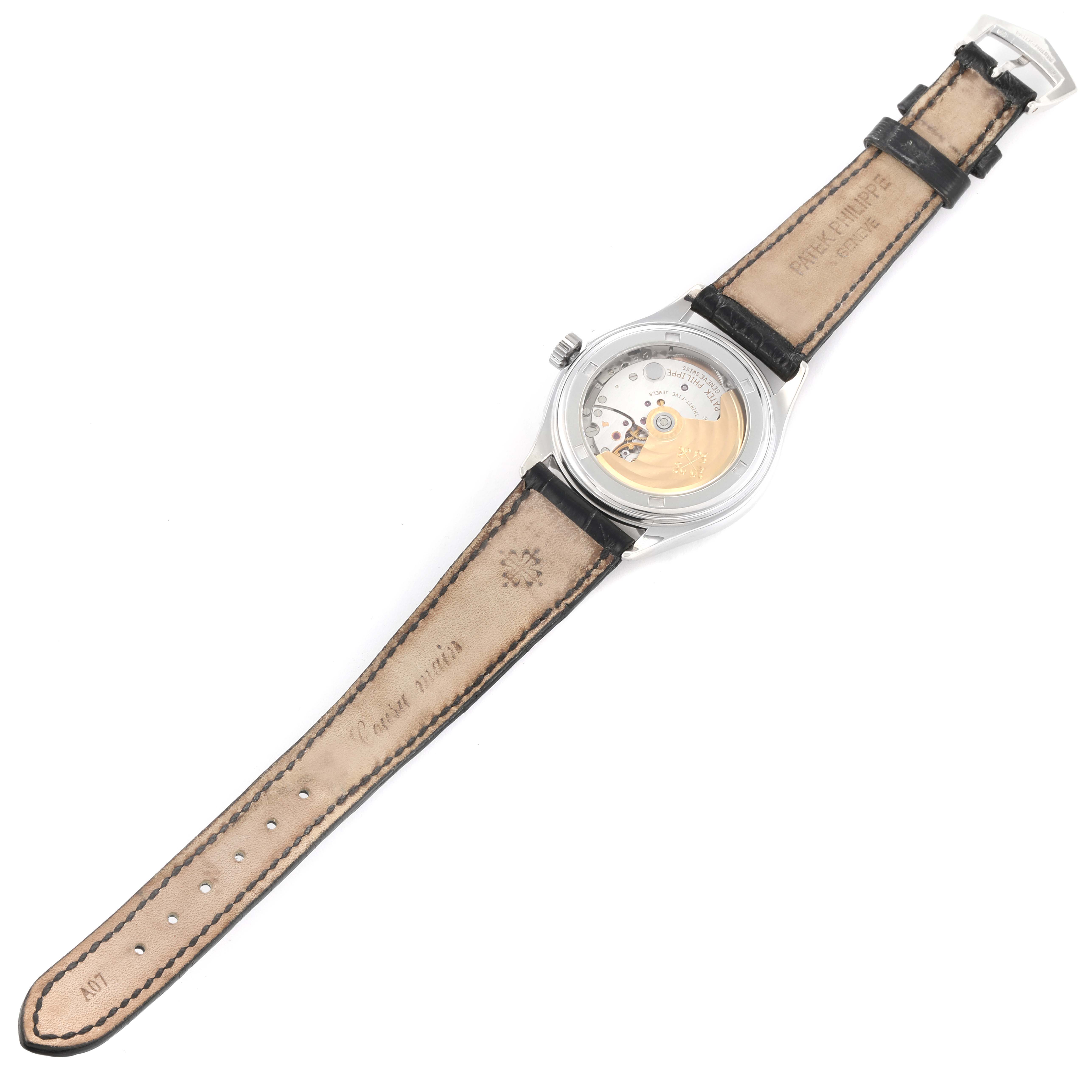 The image shows the back view of the Patek Philippe Complications 5035G Men's White Gold Black Dial 5035G Men's White Gold Black Dial model watch, highlighting its strap and movement.