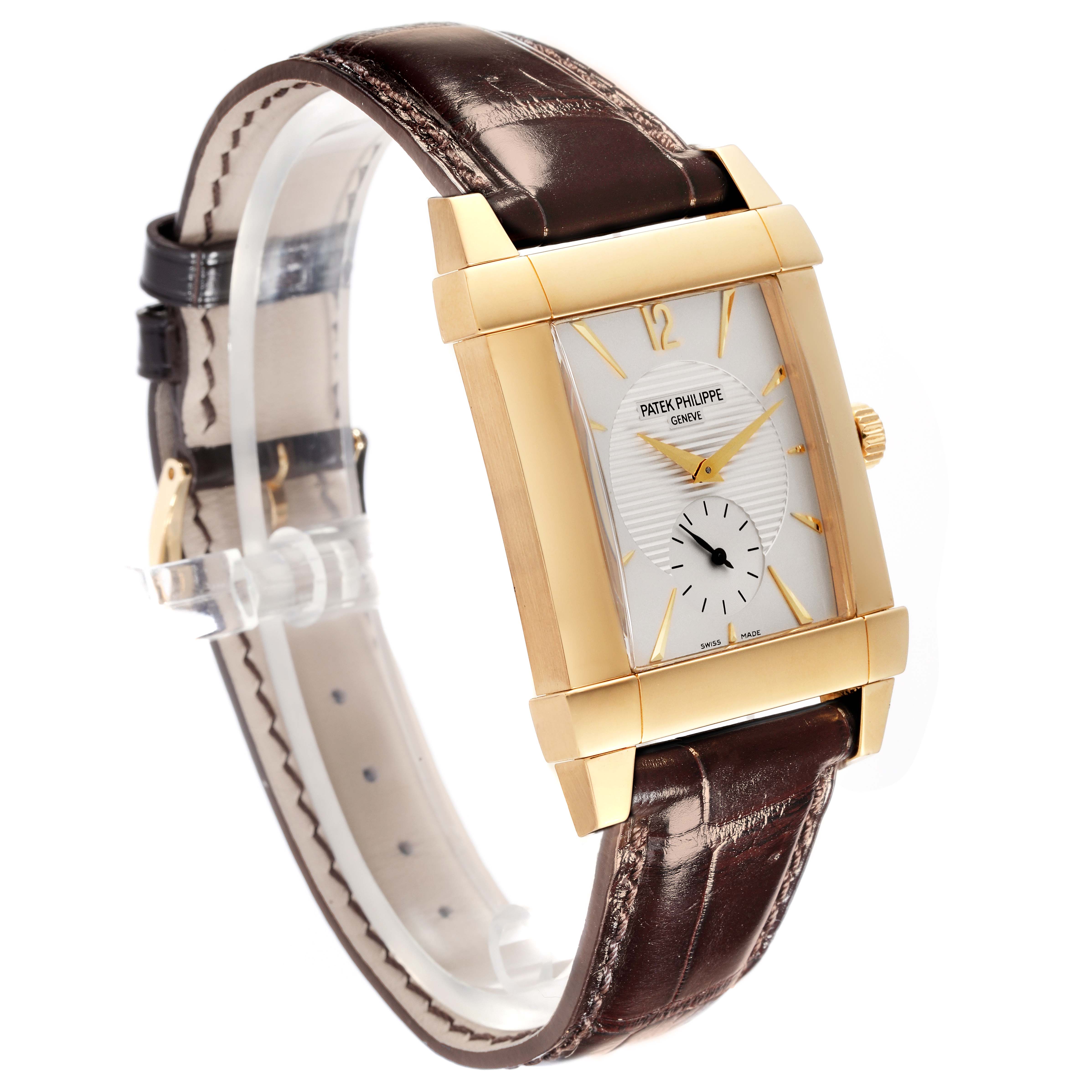 This image shows a side angle of the Patek Philippe Gondolo 5111J Men's Yellow Gold Silver Dial 5111J Men's Yellow Gold Silver Dial watch, highlighting its rectangular gold case, white dial, and brown leather strap.